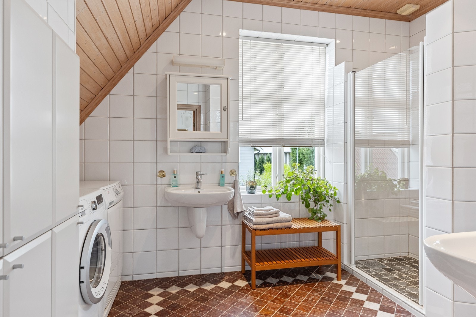 Badet er flislagt, og har opplegg til vaskemaskin. Galleribilde