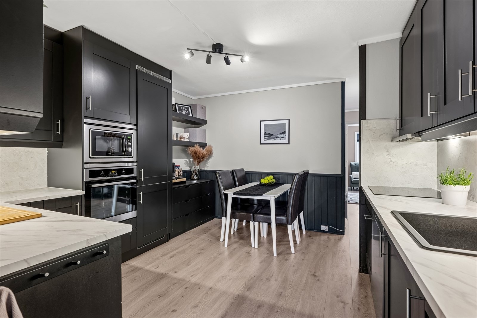 Stilrent kjøkken i sort utførelse. Profilerte fronter og benkeplate av typen laminat. Galleribilde