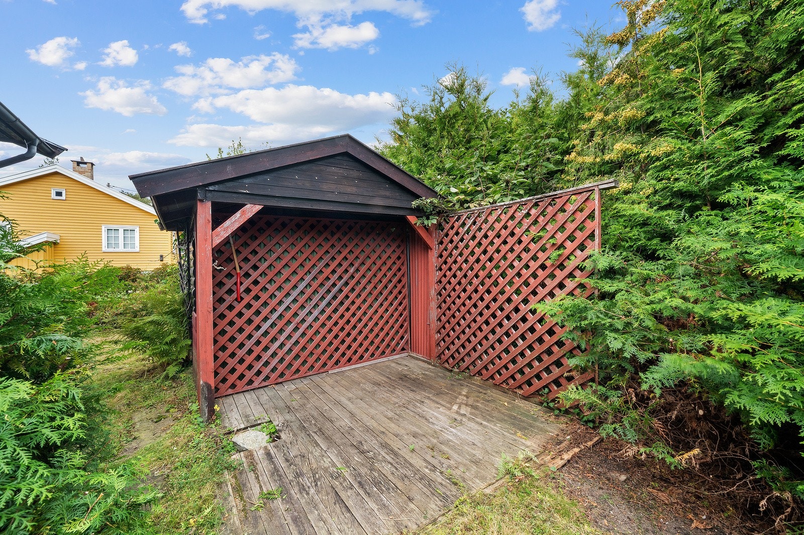 På tomten er det også en funksjonell utebod med plass til hageredskaper, verktøy eller sesongutstyr. Galleribilde