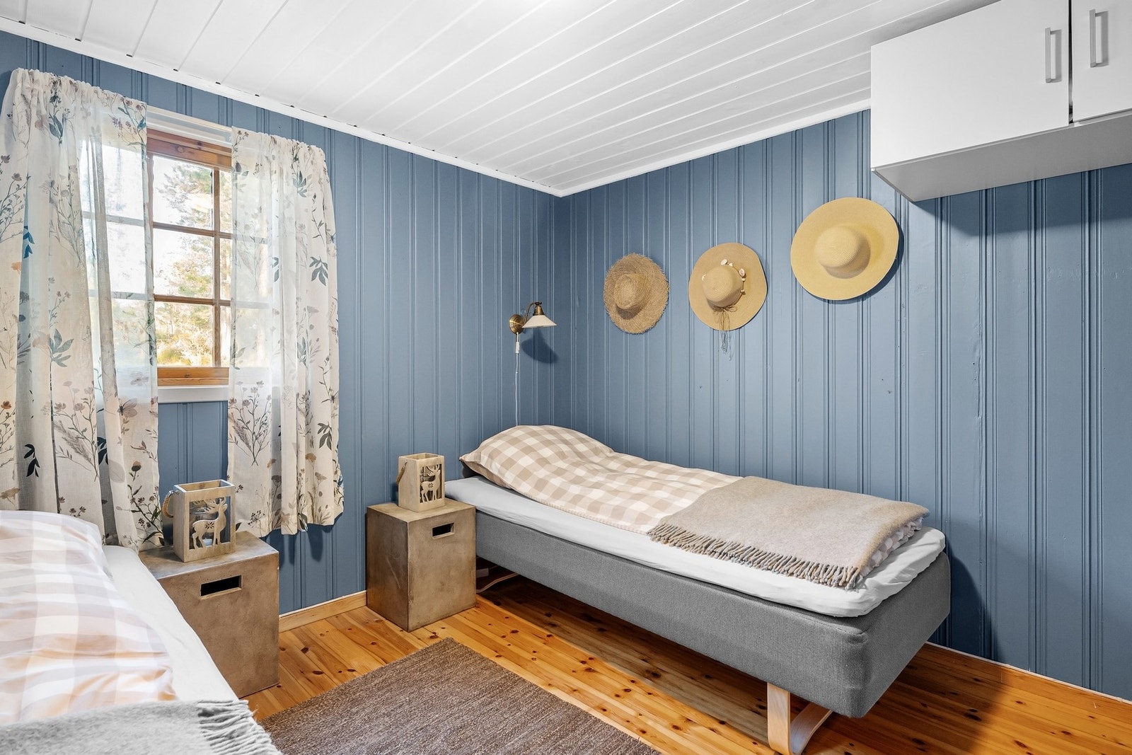Det andre soverommet er malt i en delikat blå farge og har plass til to enkeltsenger og nattbord. Galleribilde