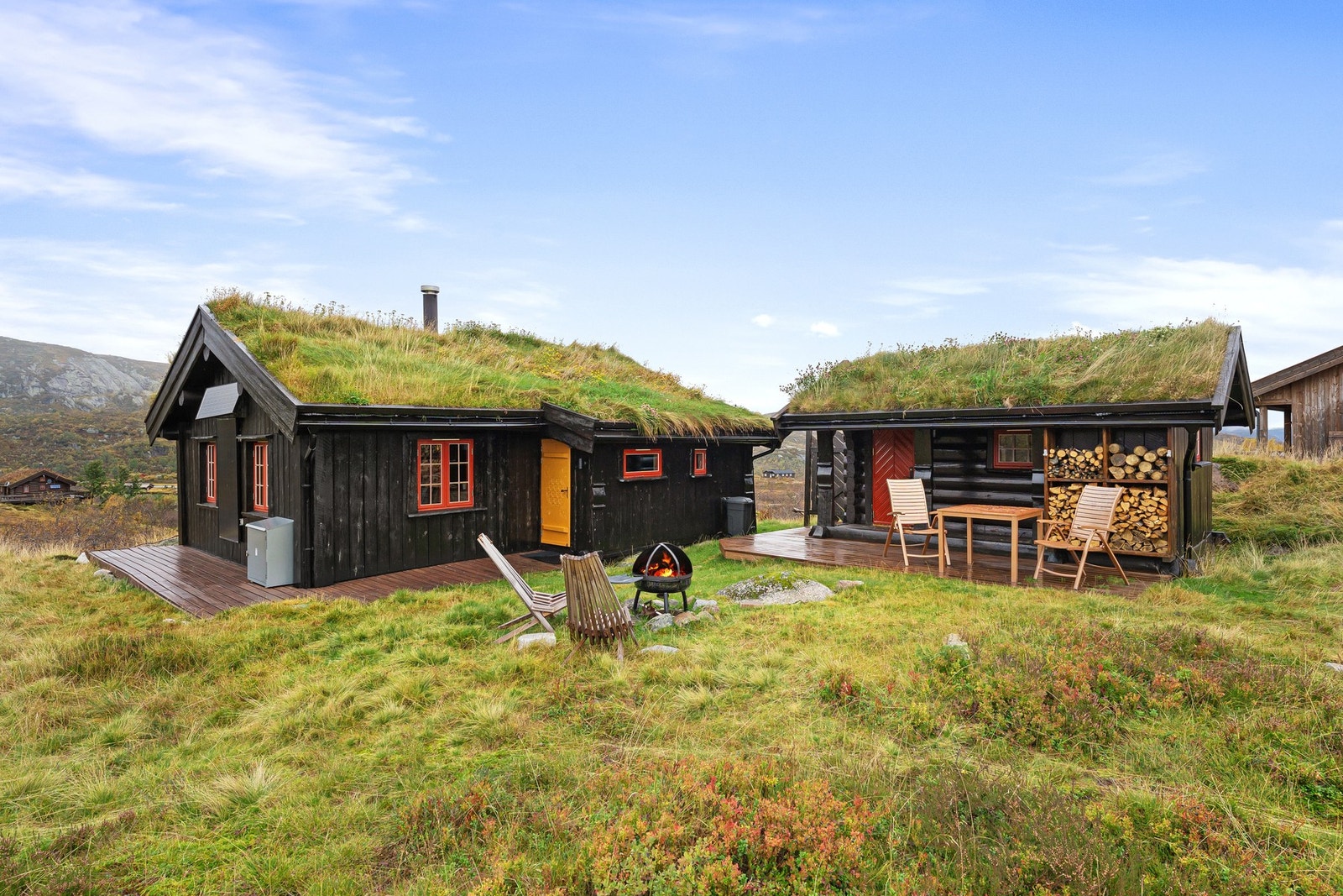 Uthuset skaper et naturlig og usjenert tun mellom bygningene. Det er anlagt terrasse utenfor hytta og uthuset. Galleribilde