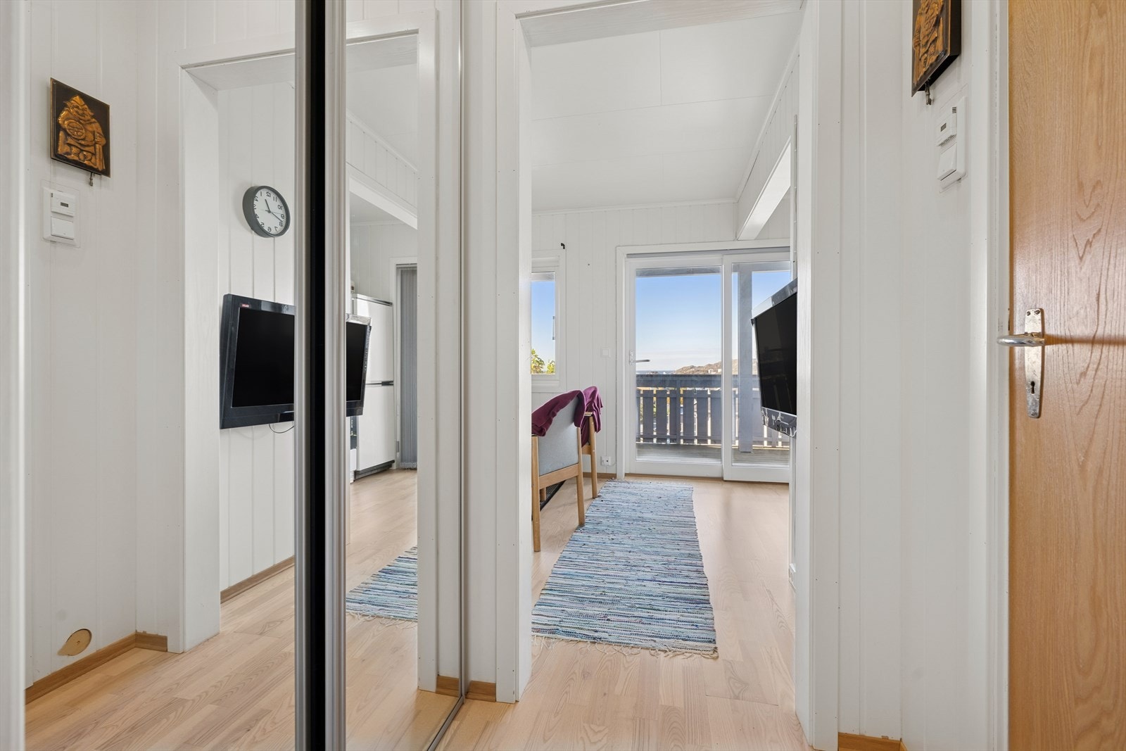 Lys og hyggelig entré med praktisk innebygget skyvedørsgarderobe. Galleribilde