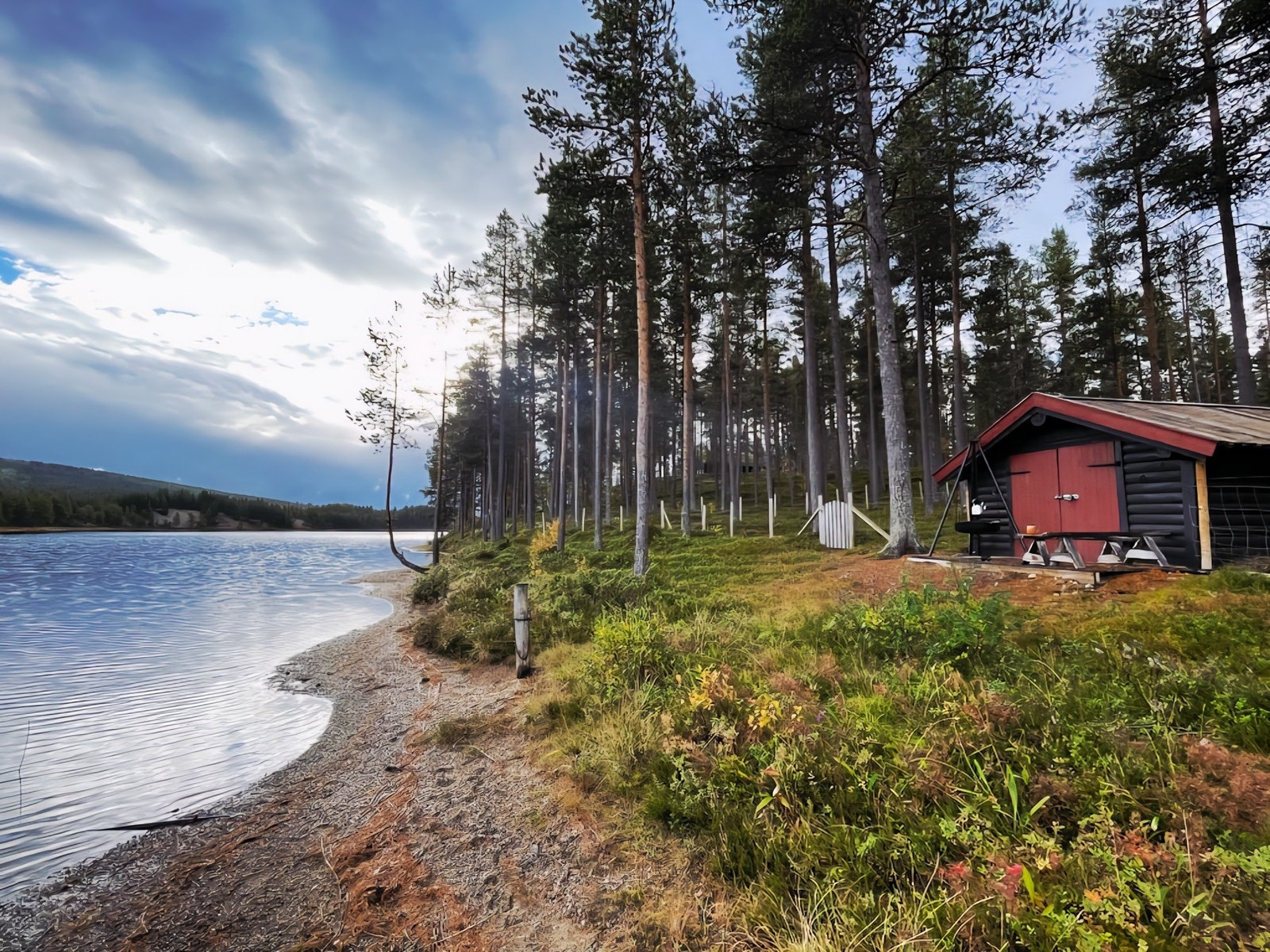 Eiendommen går ned til strandlinjen og har eget båthus. (Selgers private bilde) Galleribilde