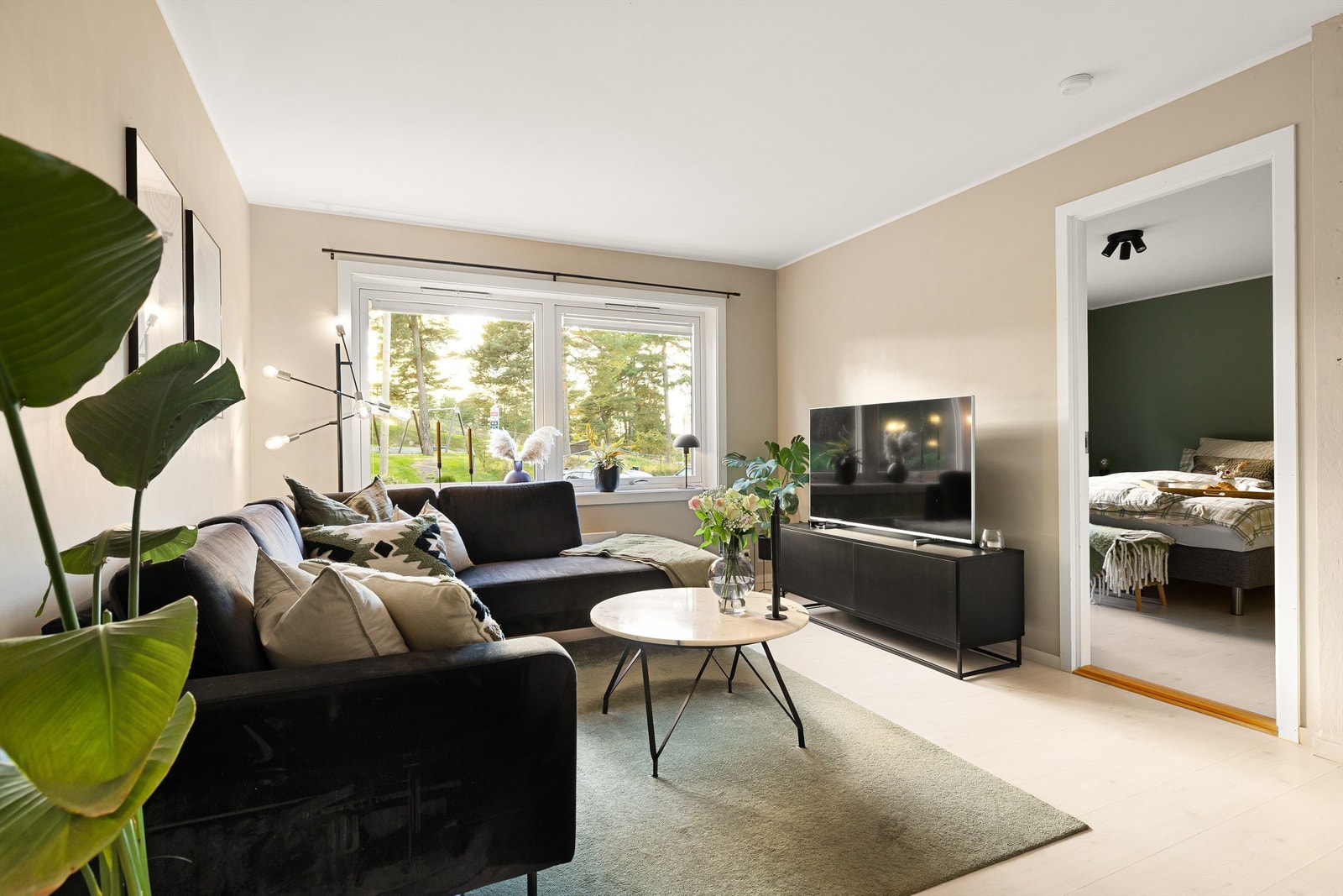 Stuen har store vinduer som slipper inn rikelig med naturlig lys. Galleribilde