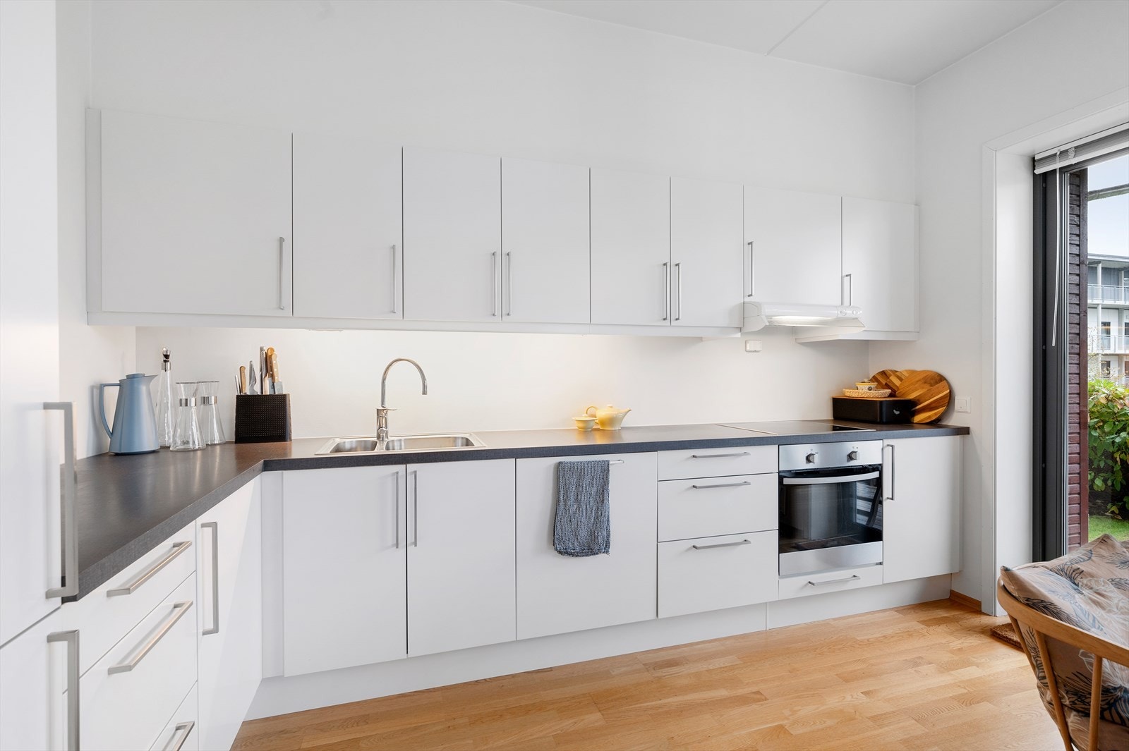 Lyst og moderne kjøkken med integrerte hvitevarer. Galleribilde