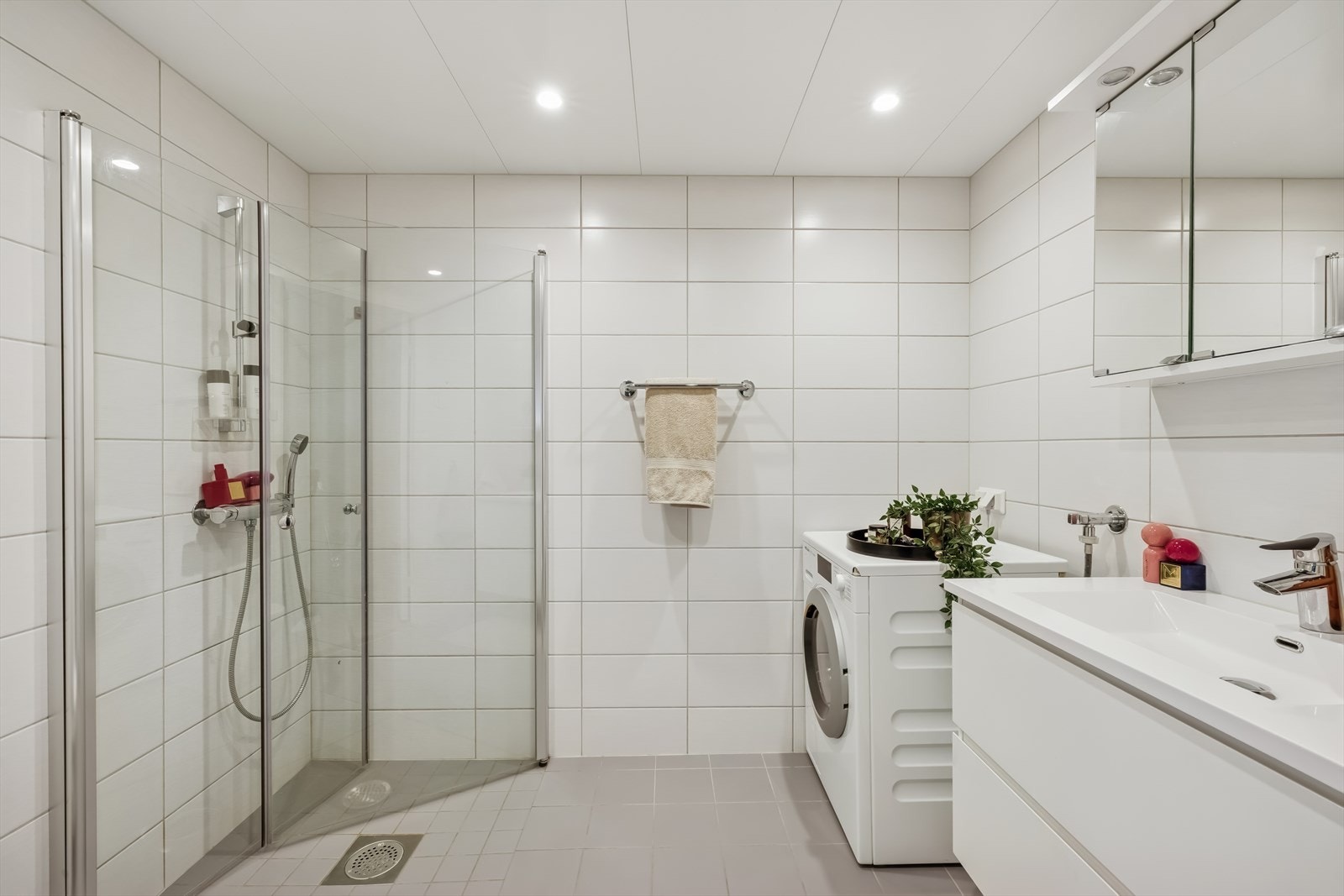 Det er pent med lyse fliser på vegger og gulv, samt spotter i tak. Galleribilde