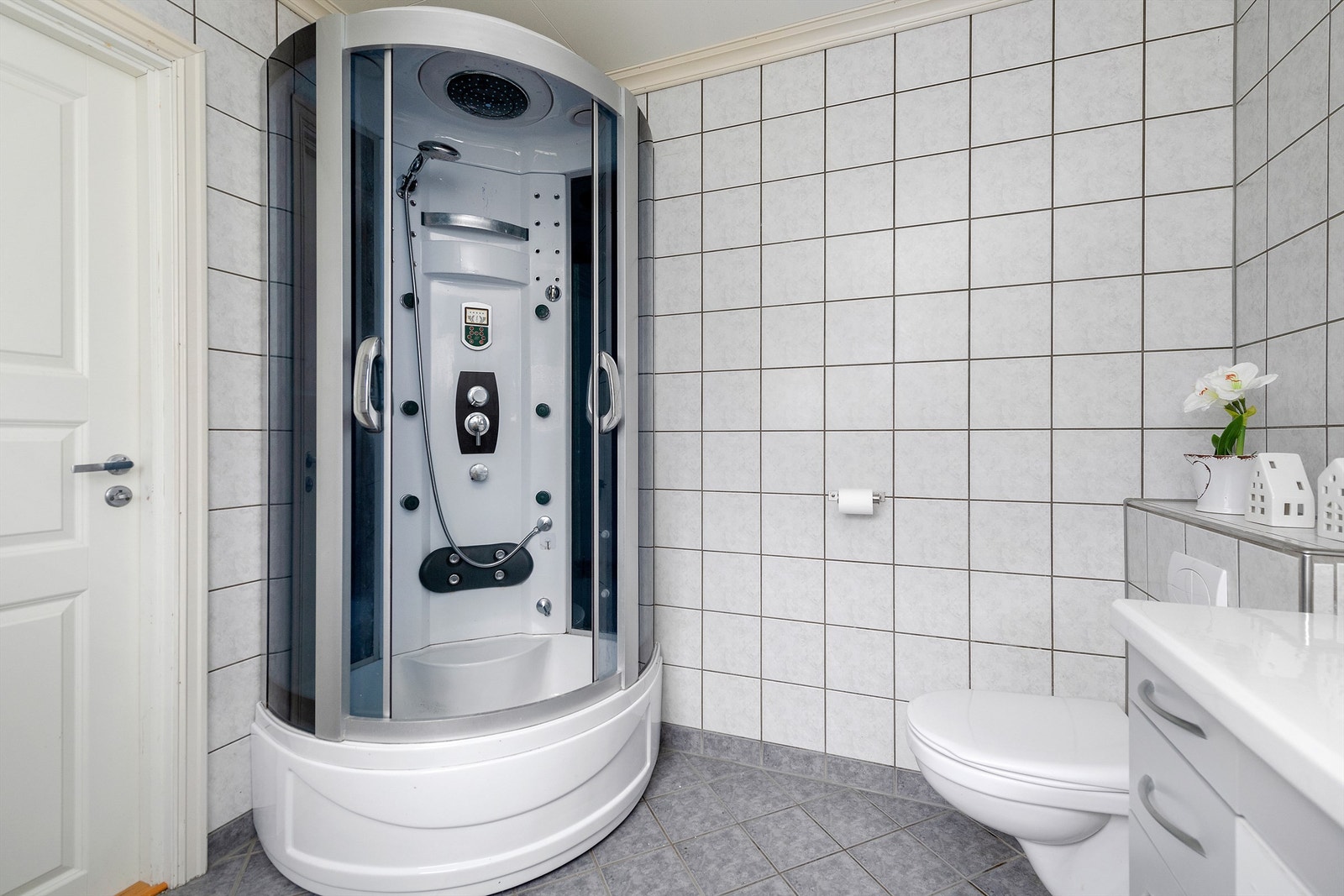 I rommet er det baderomsinnredning, vegghengt toalett og dusjkabinett Galleribilde