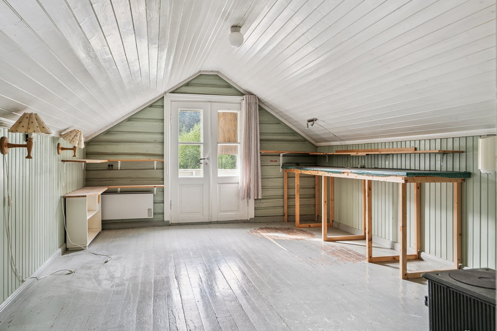 Soverom/hobbyrommet på loftet har en egen vedovn og direkte utgang til verandaen på 11 m². Galleribilde