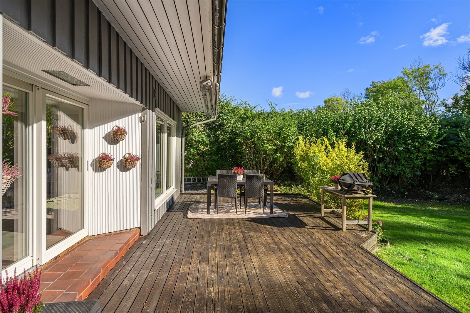 Terrassen har direkte adkomst fra stuen og er skjermet mot naboen - ideell for grillkvelder og rolige stunder. Galleribilde