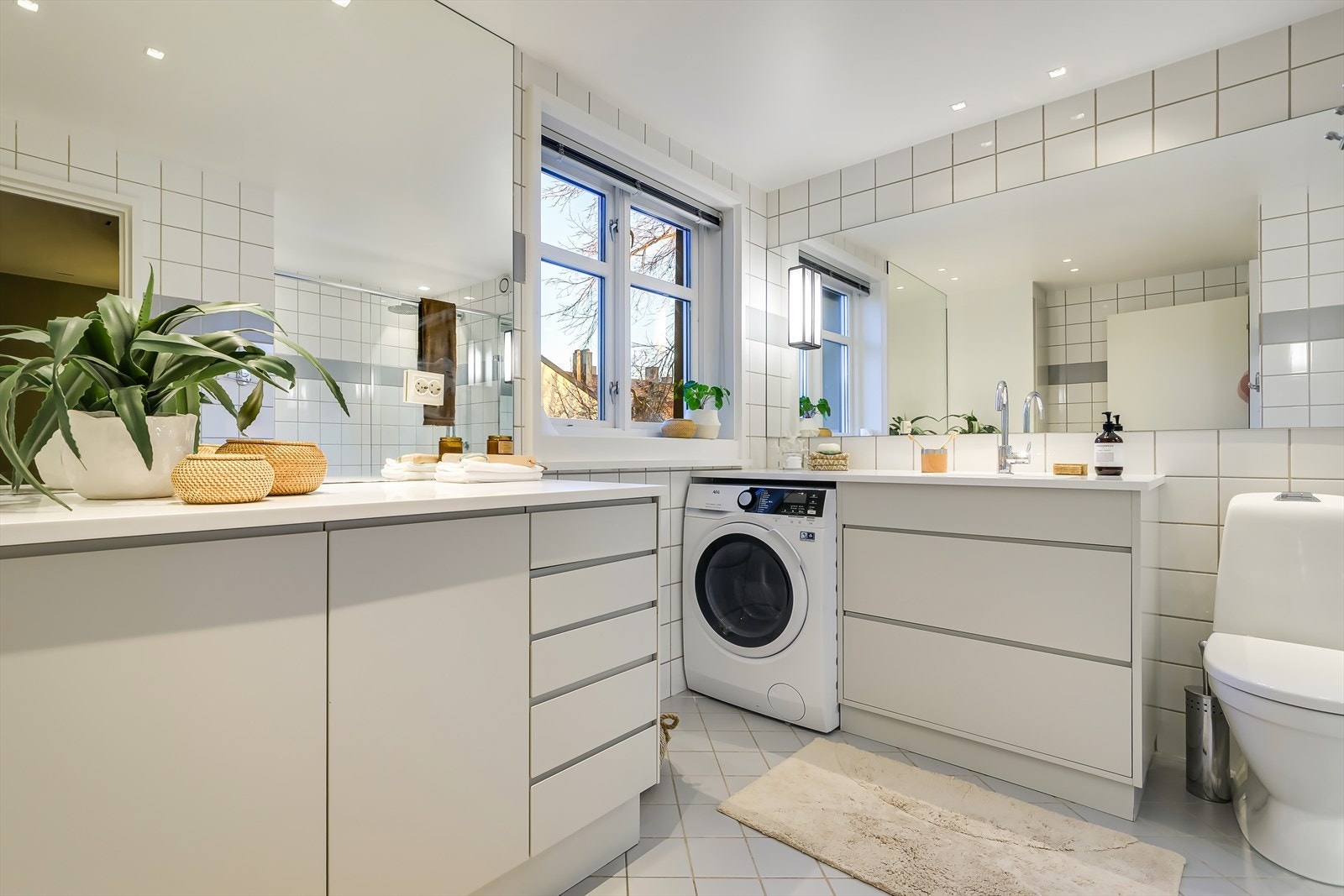 Delikat og praktisk bad med flislagte overflater og god romfølelse. Galleribilde