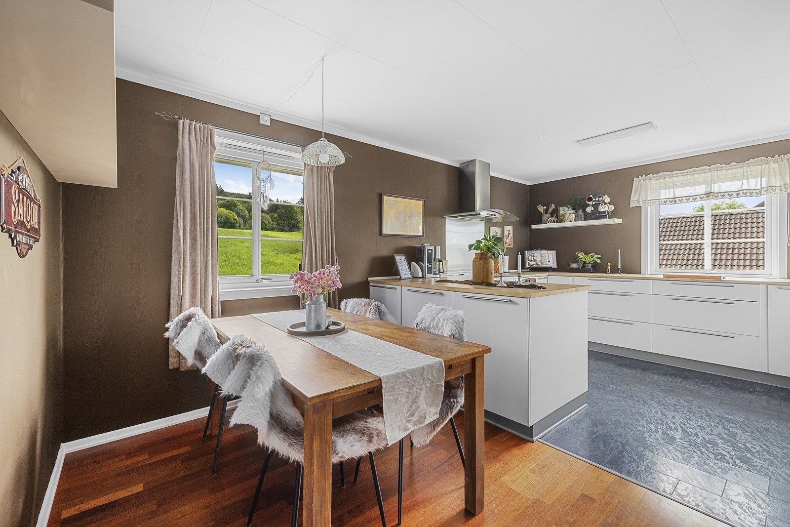 Fra stuen kommer man inn i romslig kjøkken med koselig spiseplass Galleribilde