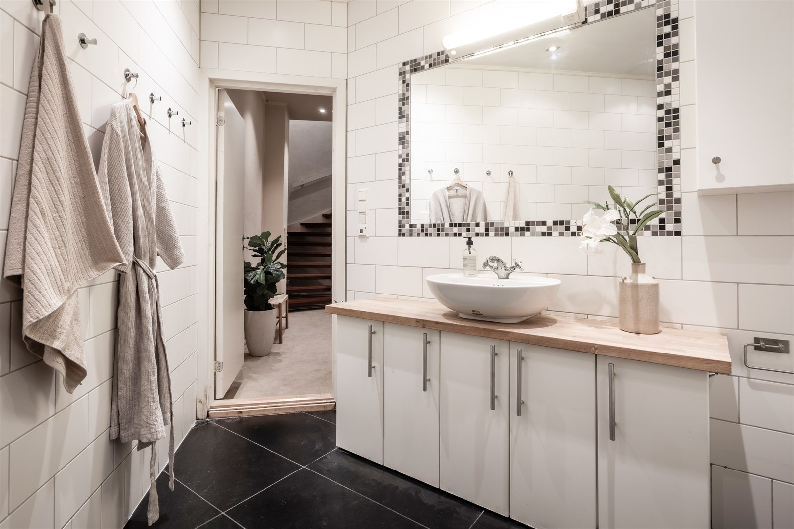 Badet er utstyrt med vegghengt toalett, skålservant og downlights i taket. Galleribilde