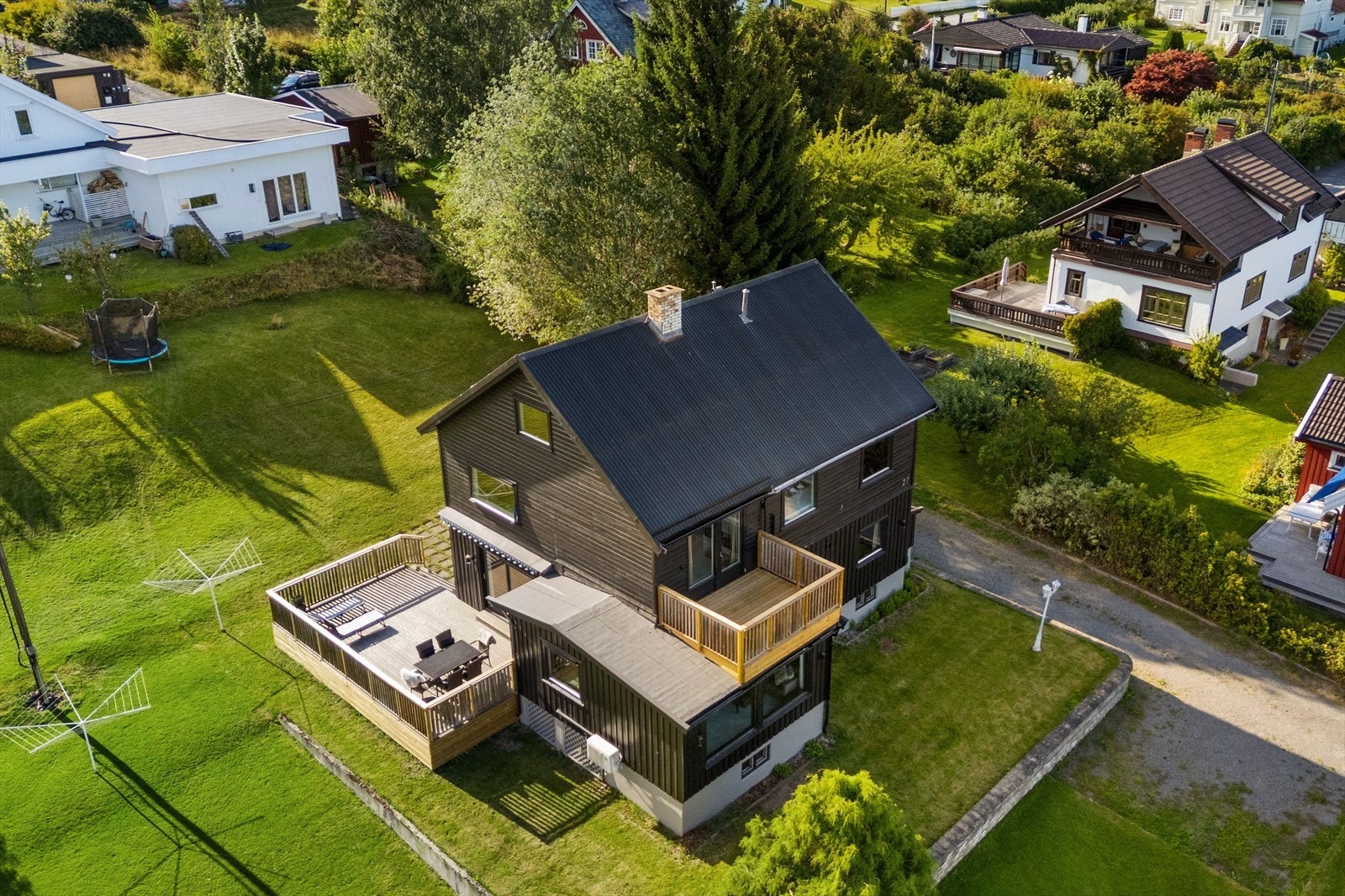 Dronebilde av eiendommen med fine uteplasser og hageareal Galleribilde