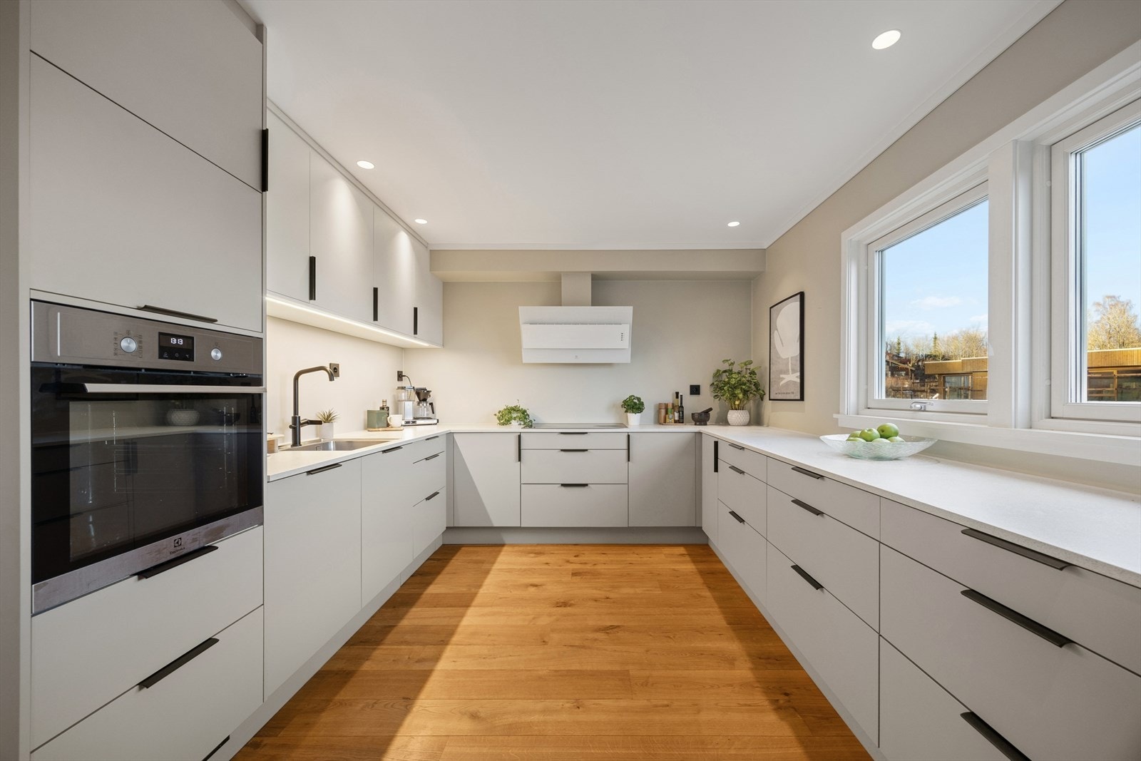 Kjøkkenet har HTH-innredning fra 2022 med glatte fronter og laminat benkeplate med underlimt kum i rustfritt stål. Galleribilde