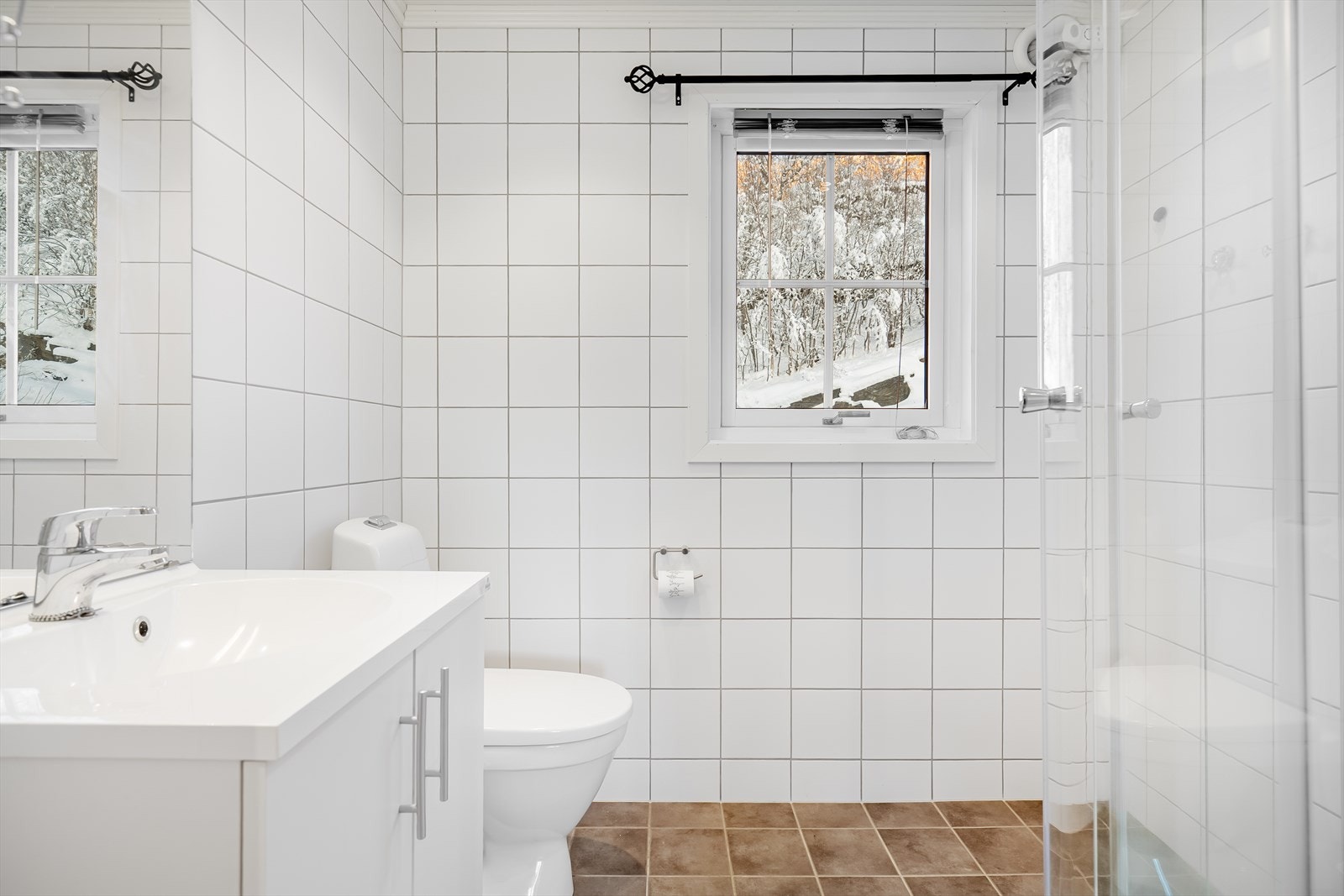 Bad innredet med servant, gulvtoalett og dusjkabinett.
Det er elektrisk styrt vifte. Galleribilde