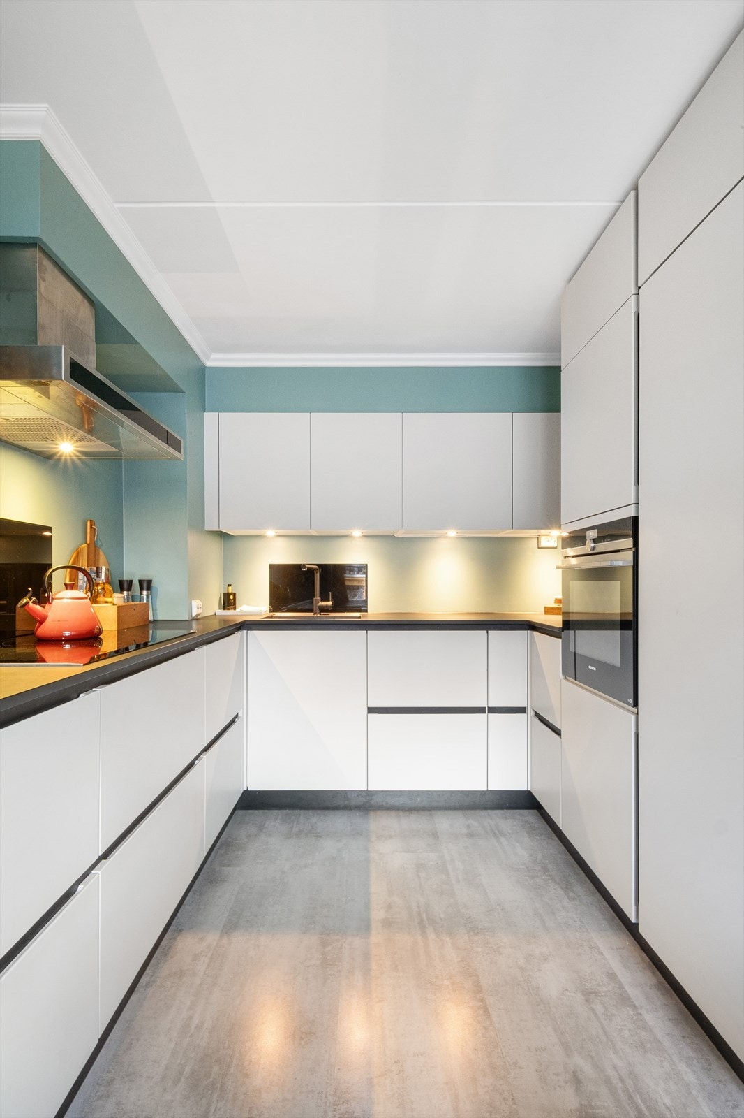 Kjøkkeninnredning med glatte fronter og integrerte hvitevarer Galleribilde