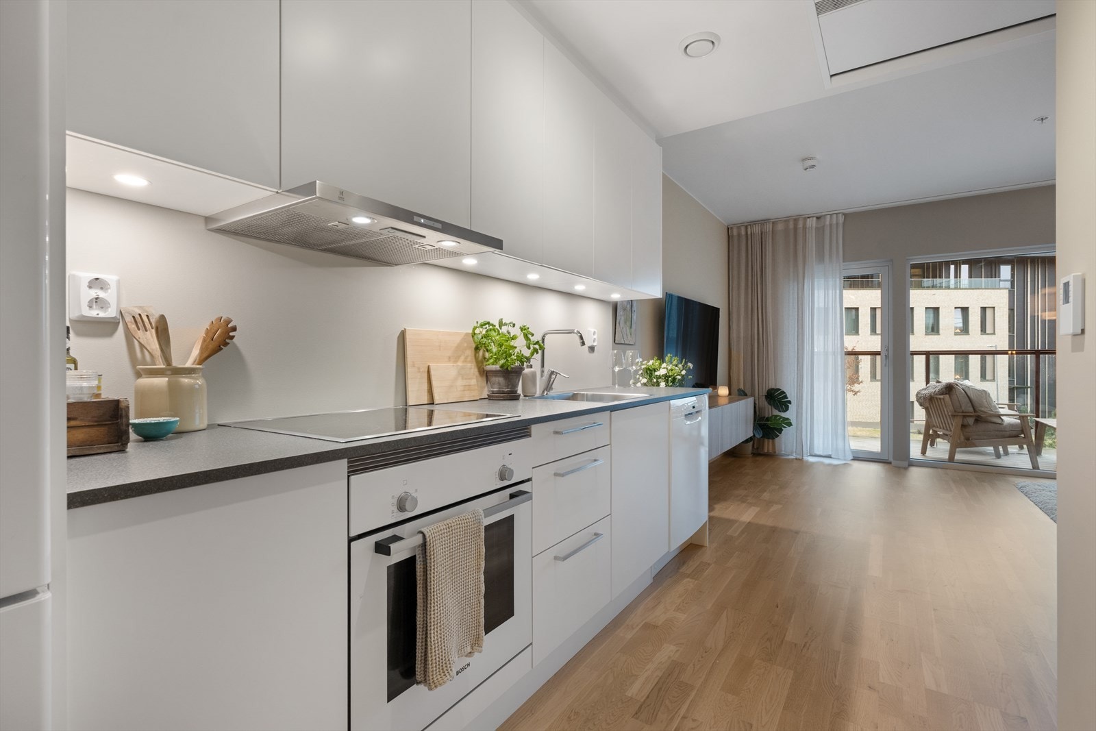 Tidløs lys kjøkkeninnredning med glatte fronter. Galleribilde