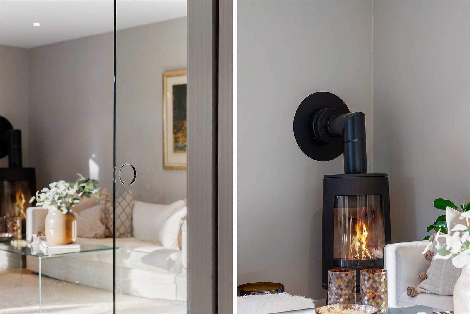 I hjørnet av stuen står en moderne, svart peisovn som skaper en varm og innbydende atmosfære Galleribilde