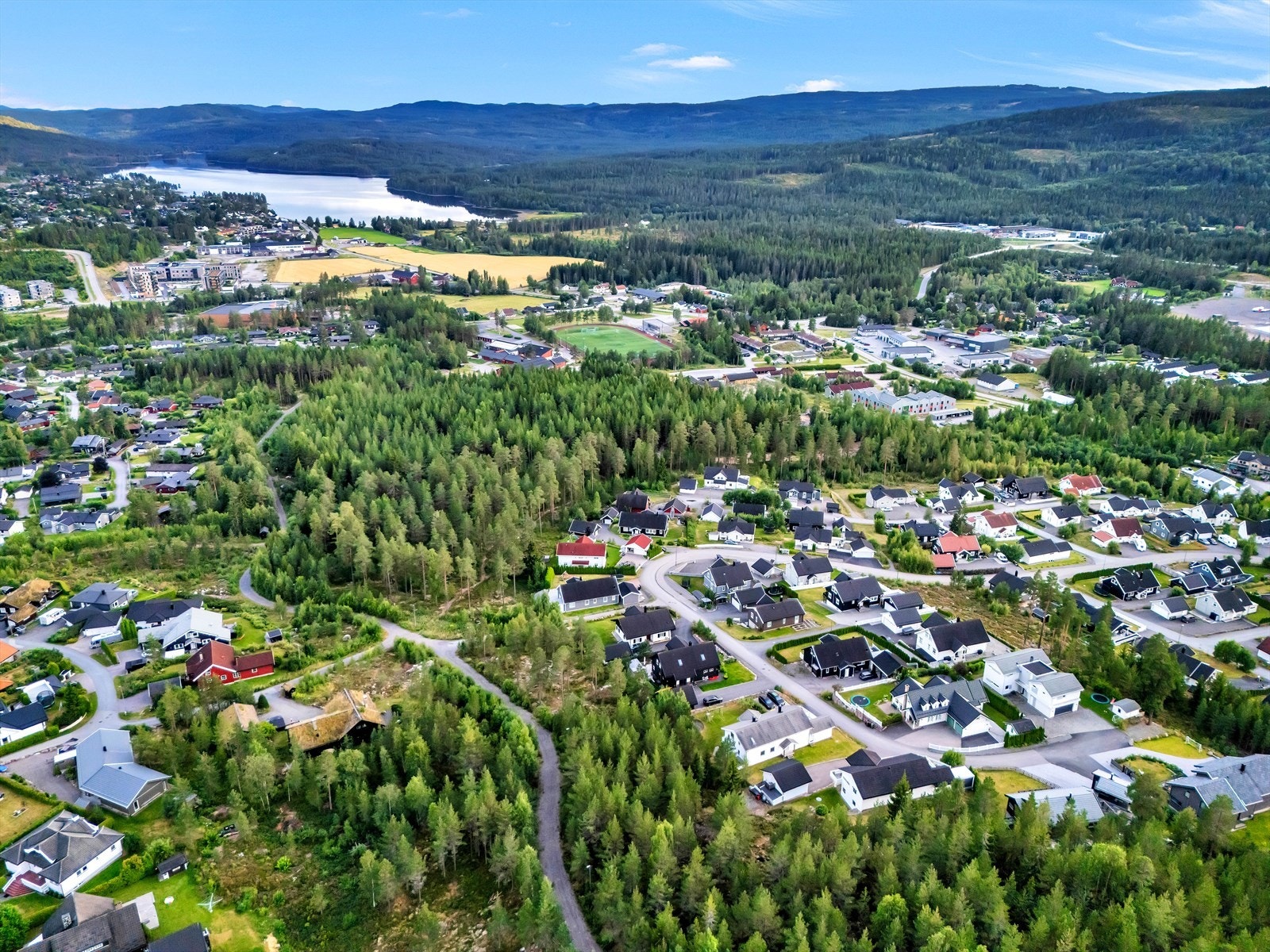 Trygg skolevei via den trafikkfrie gangstien Skolebakken. Enkel gangvei til idrettsaktiviteter på Harestua stadion og Harestua Arena Galleribilde