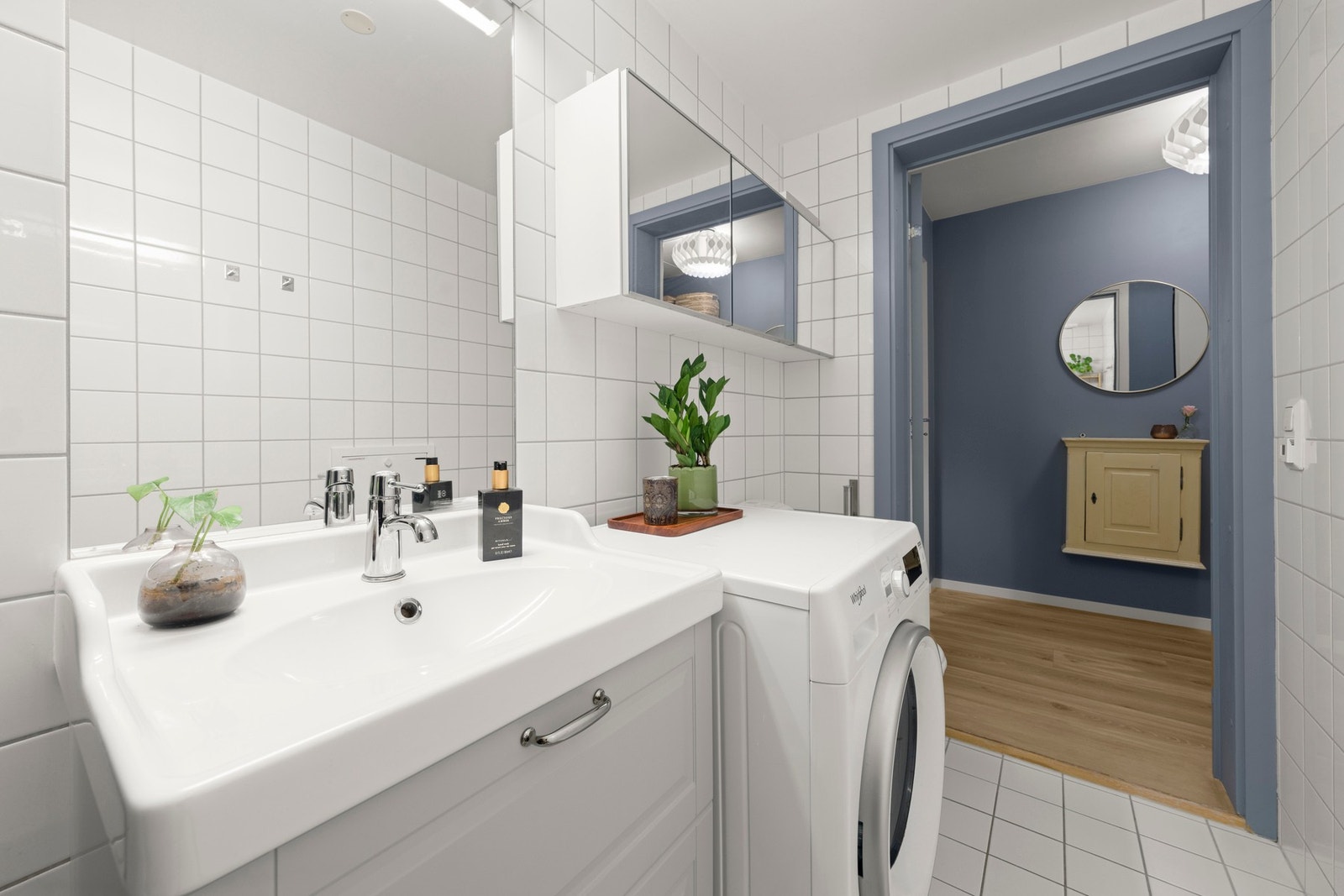 Innredningen består av servant med underskap, speilskap med belysning, gulvmontert toalett og dusjnisje med innfellbare glassdører. Galleribilde