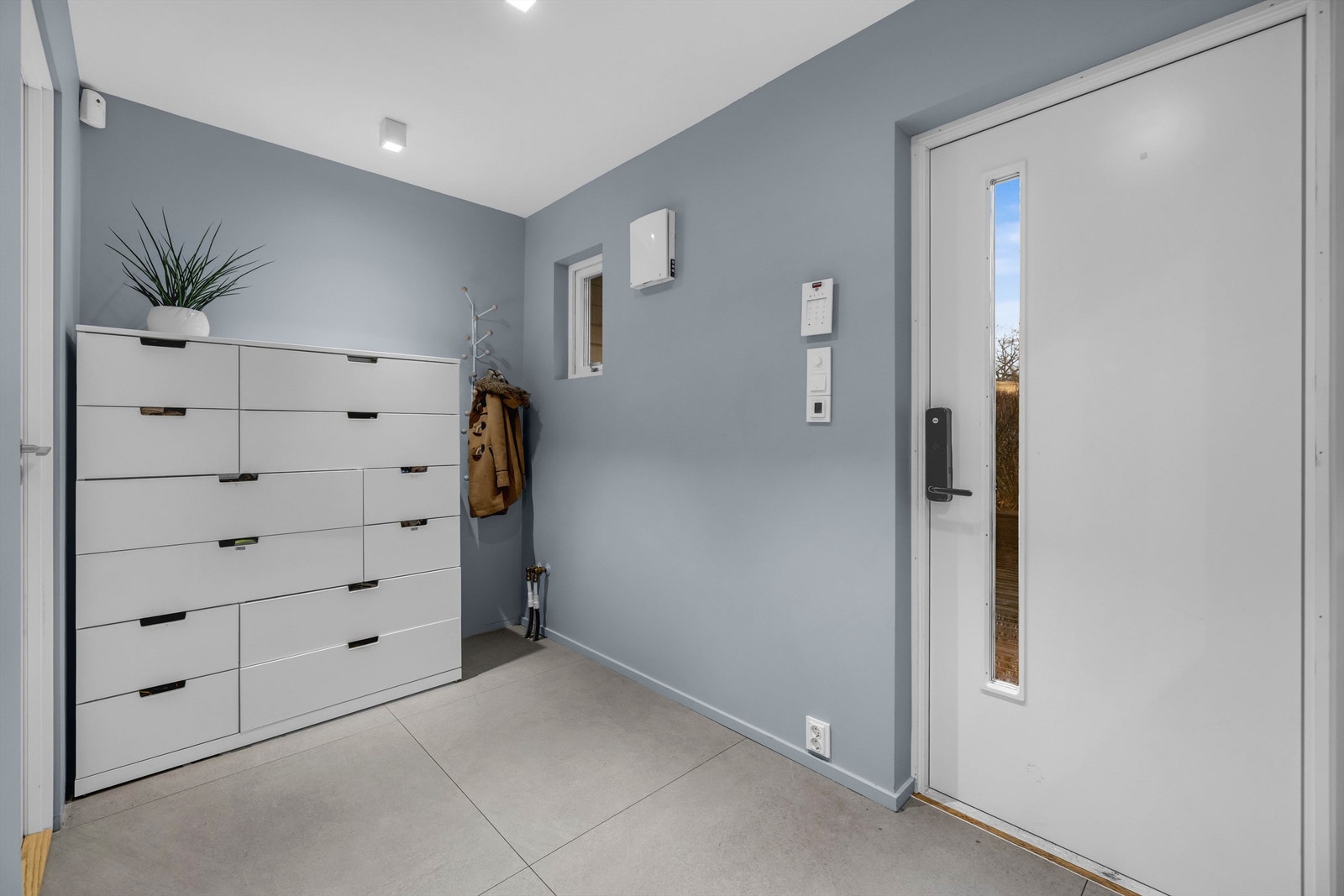 Her kan man henge fra seg jakker og sko, og entréen gir et godt førsteinntrykk av boligen. Gulvet er flislagt over lun gulvvarme. Galleribilde