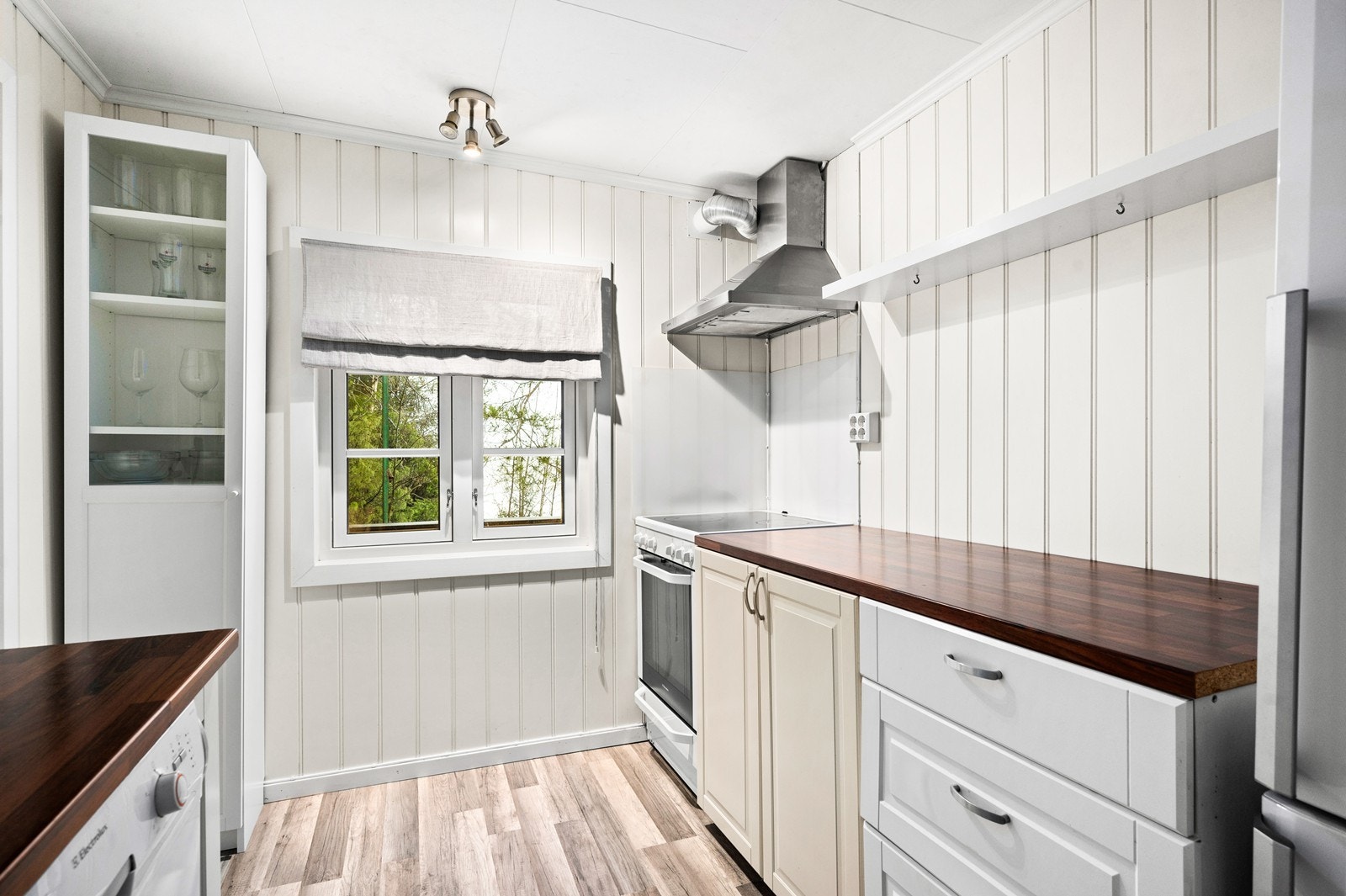 Det er kjøkkenventilator med avtrekk ut og frittstående hvitevarer. Galleribilde