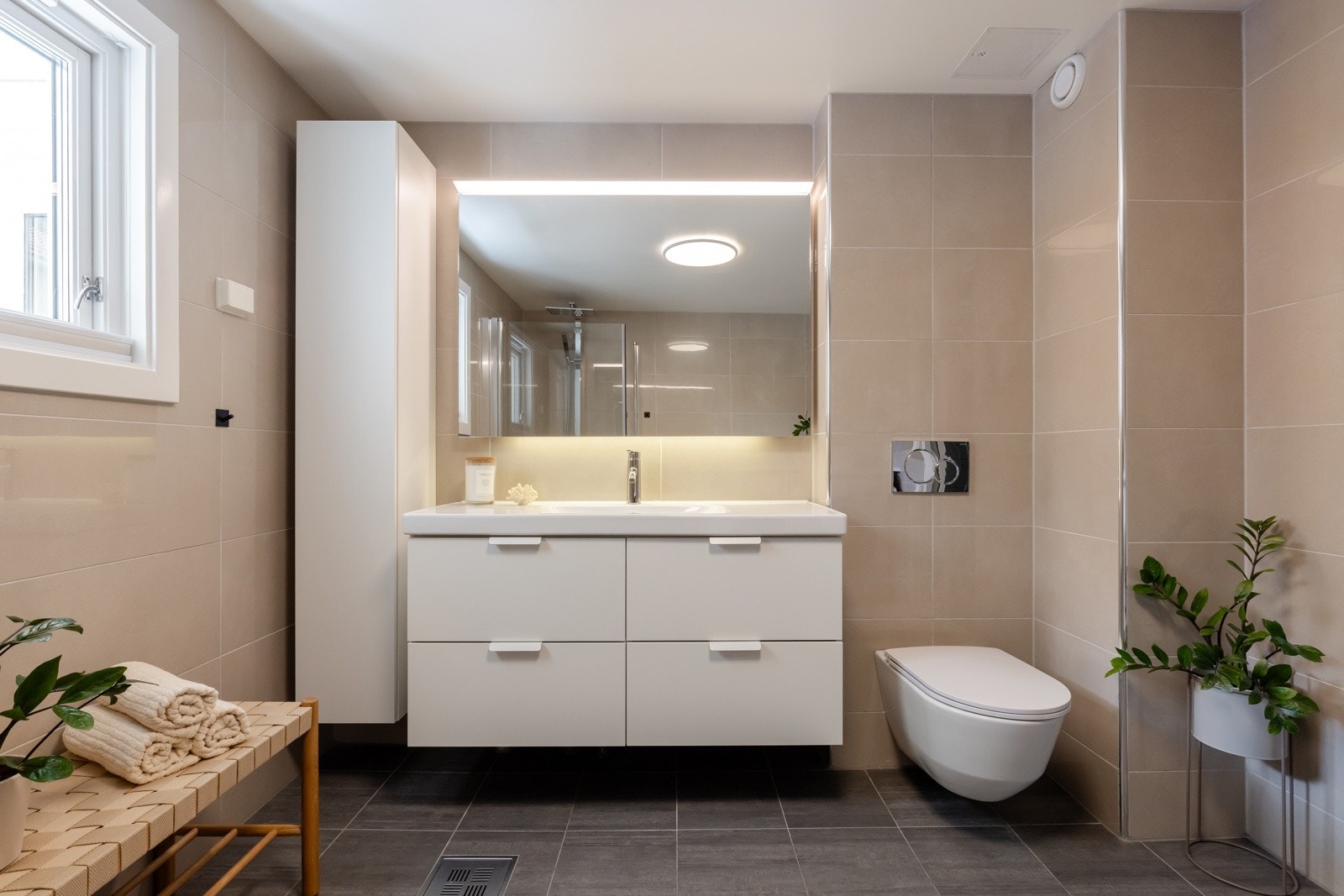 Rommet har en vegghengt servantinnredning, heldekkende servant med ett-greps armatur og speil over servant med overlys. Galleribilde