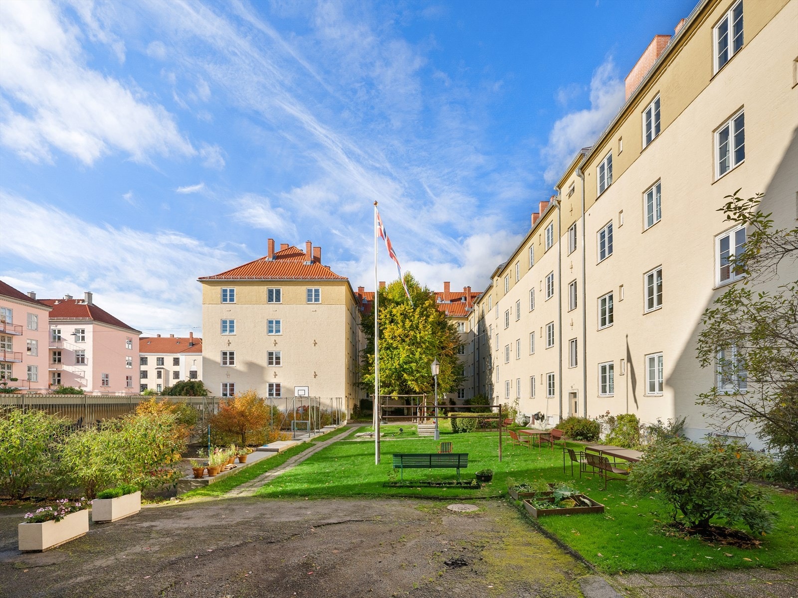 Aksjelagets fellesareal er velstelt, samt pent opparbeidet med plen, trær, prydbusker mot gaten og flaggstang Galleribilde