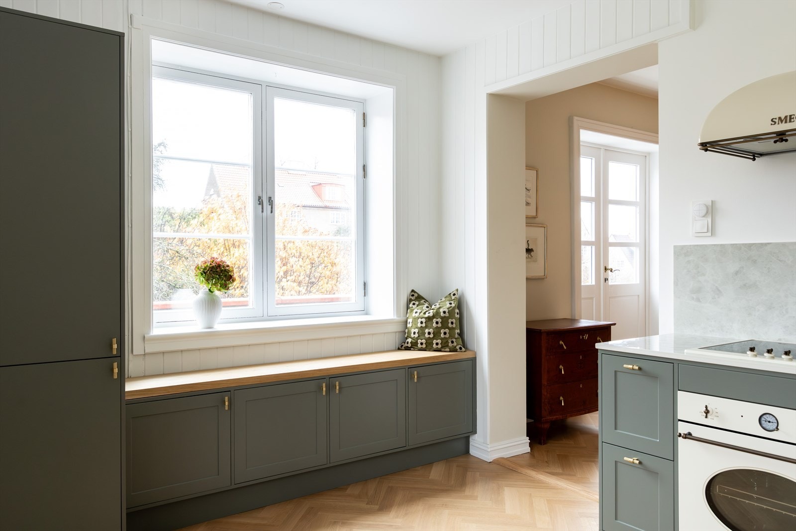 Praktisk og plassbygd sittebenk i heltre eik, som går i stil med resten av kjøkkenet. Galleribilde