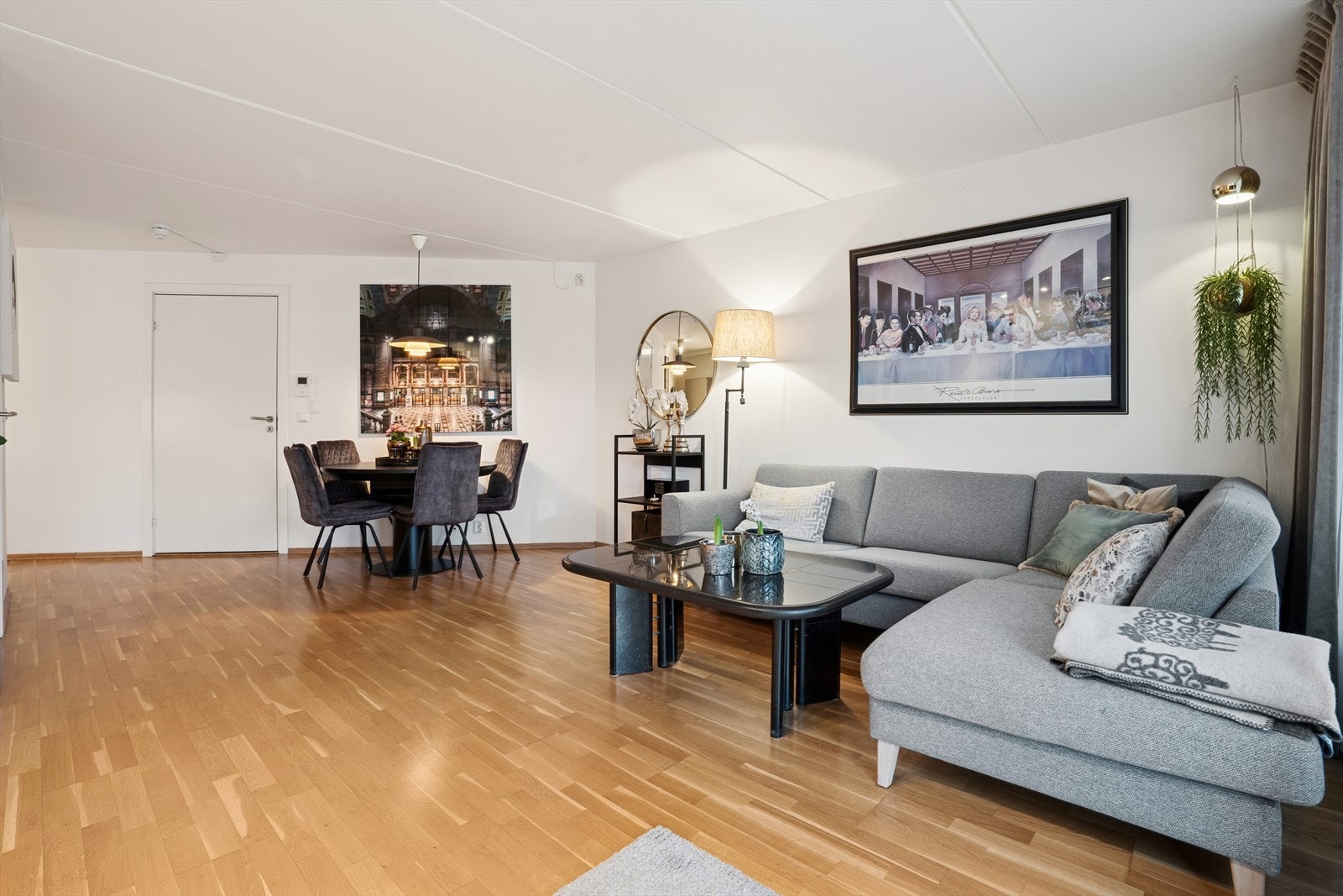 Leiligheten har en lys og innbydende stue med gjennomgående parkettgulv og lyse overflater. Her er det god plass til både en avslappende sofakrok med TV-møblement og et spisebord. Galleribilde