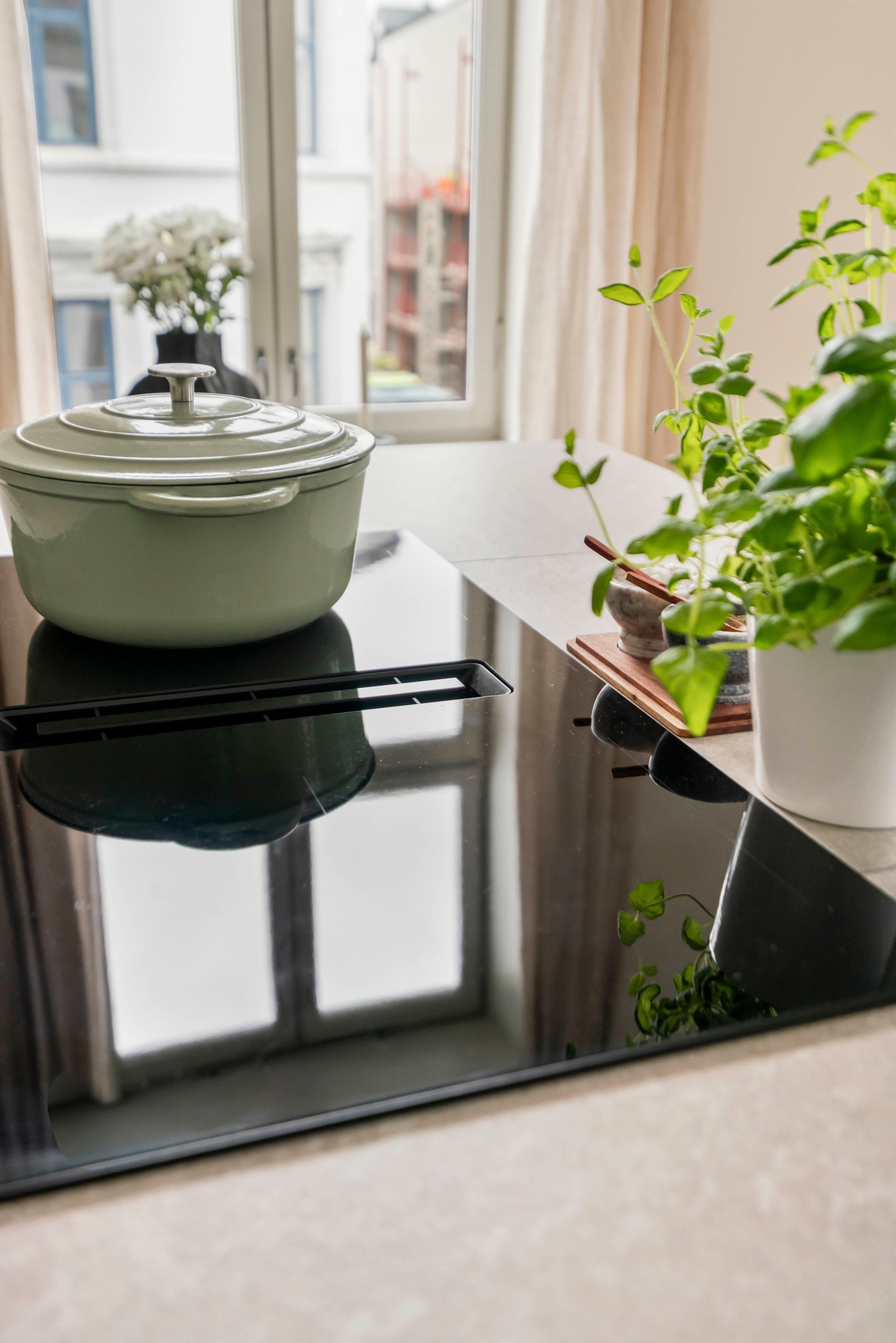 Induksjonstopp med integrert avtrekk gir en åpen og ren kjøkkenlayout Galleribilde