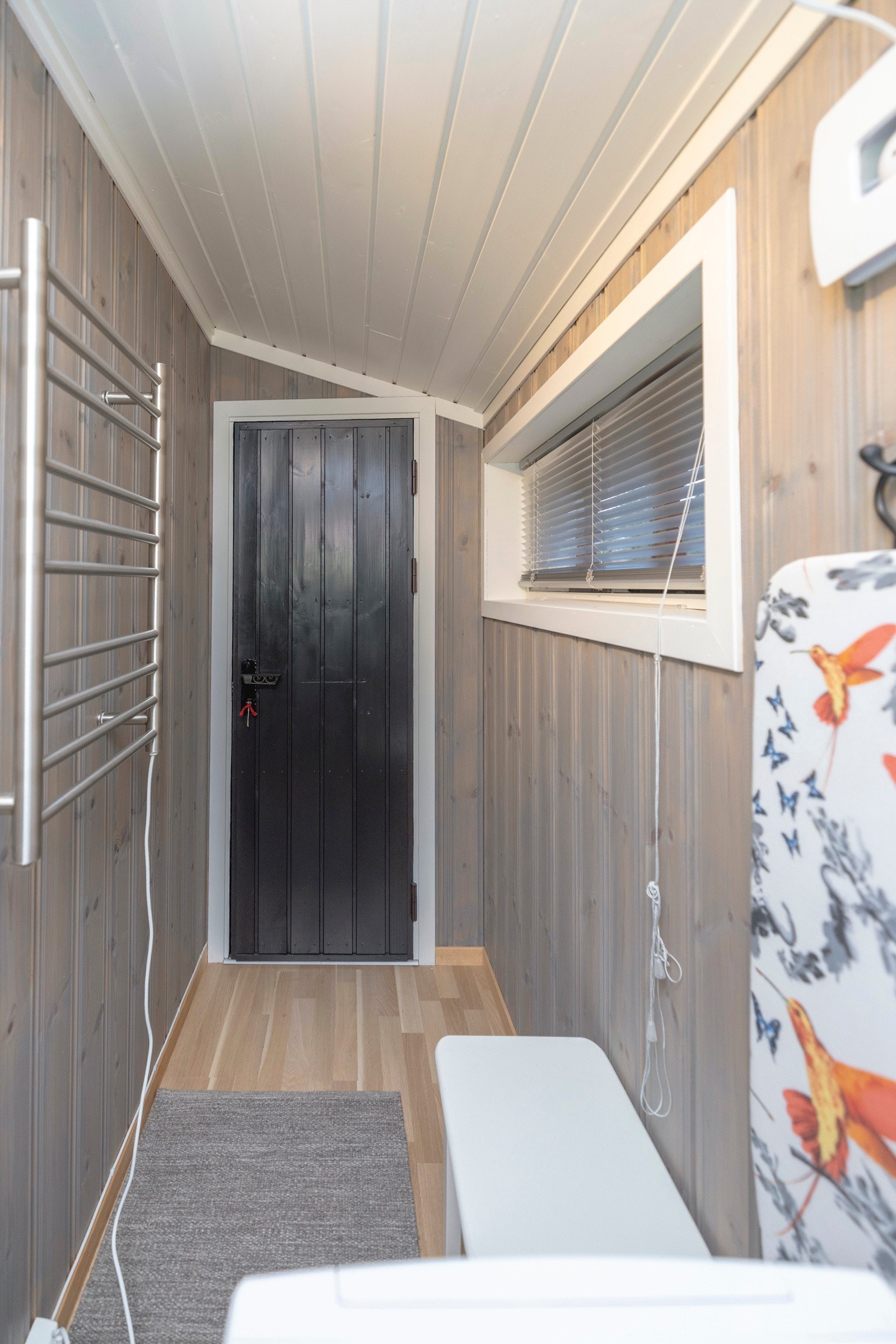 Vaskerom med parkett på gulv samt trepanel på vegger og i tak. Galleribilde