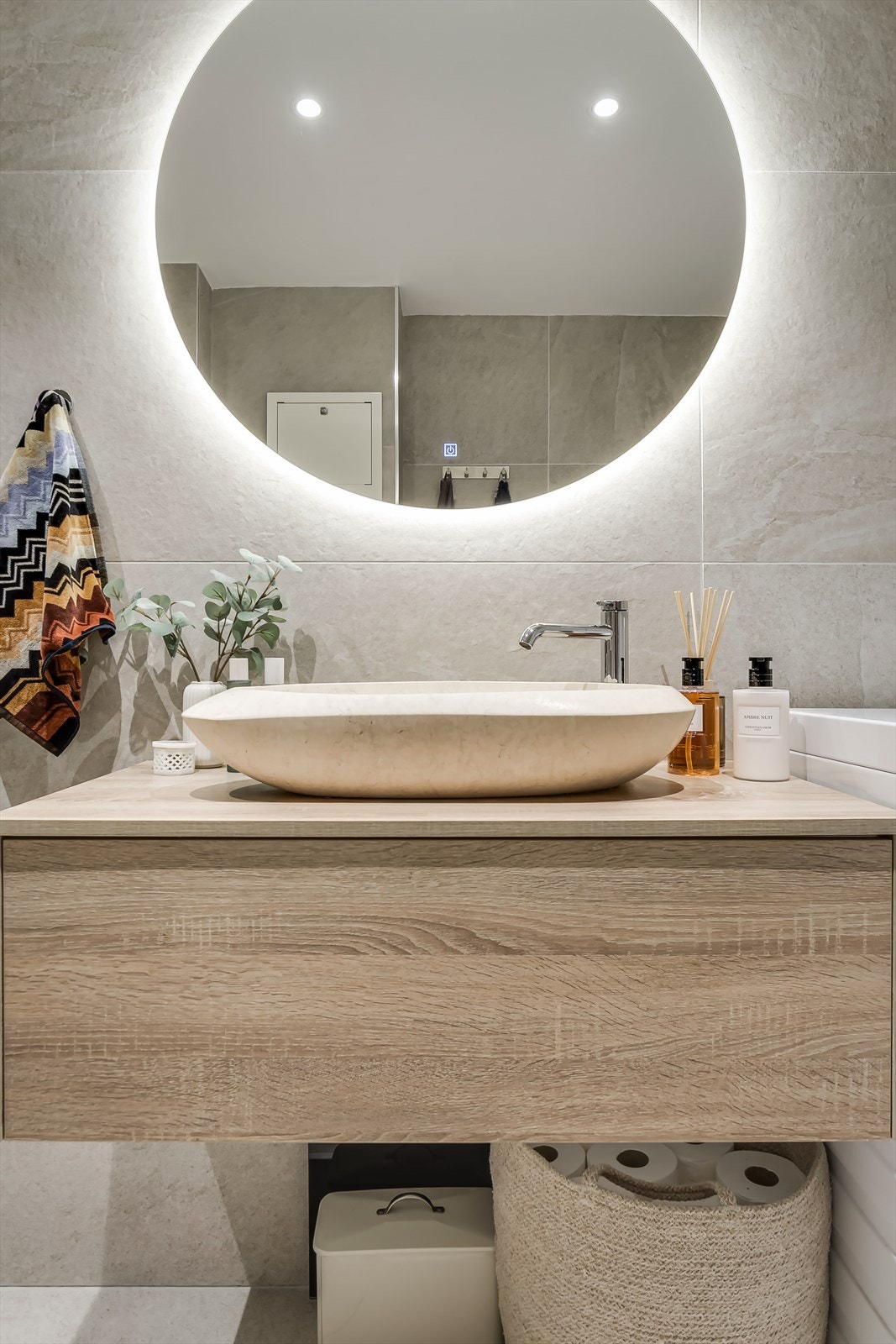 Stilren innredning med servantbolle, skap, speil, vegghengt toalett og dusjhjørne. Galleribilde