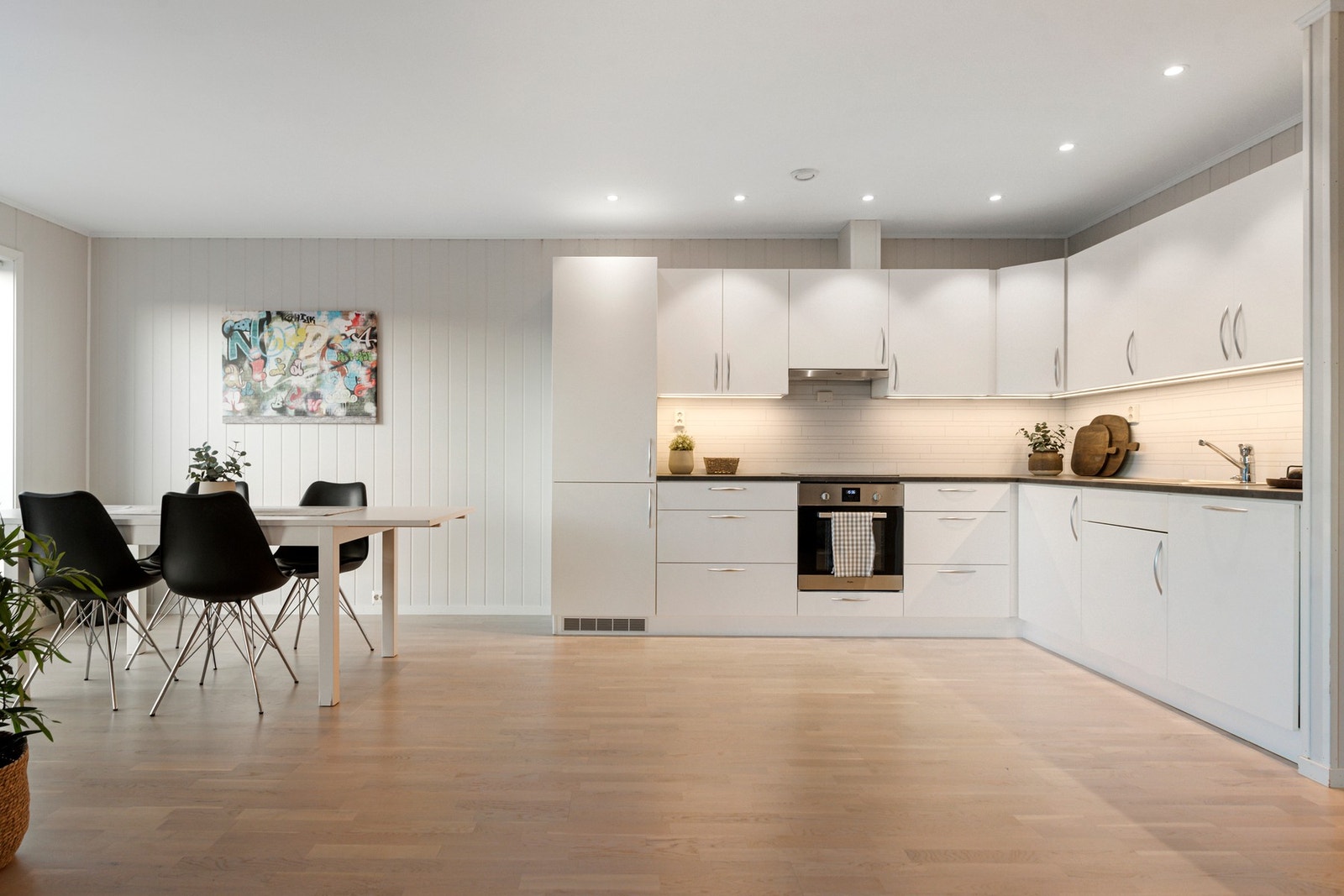 Integrerte hvitevarer som oppvaskmaskin, komfyr, platetopp og kjøl/fryseskap. Galleribilde