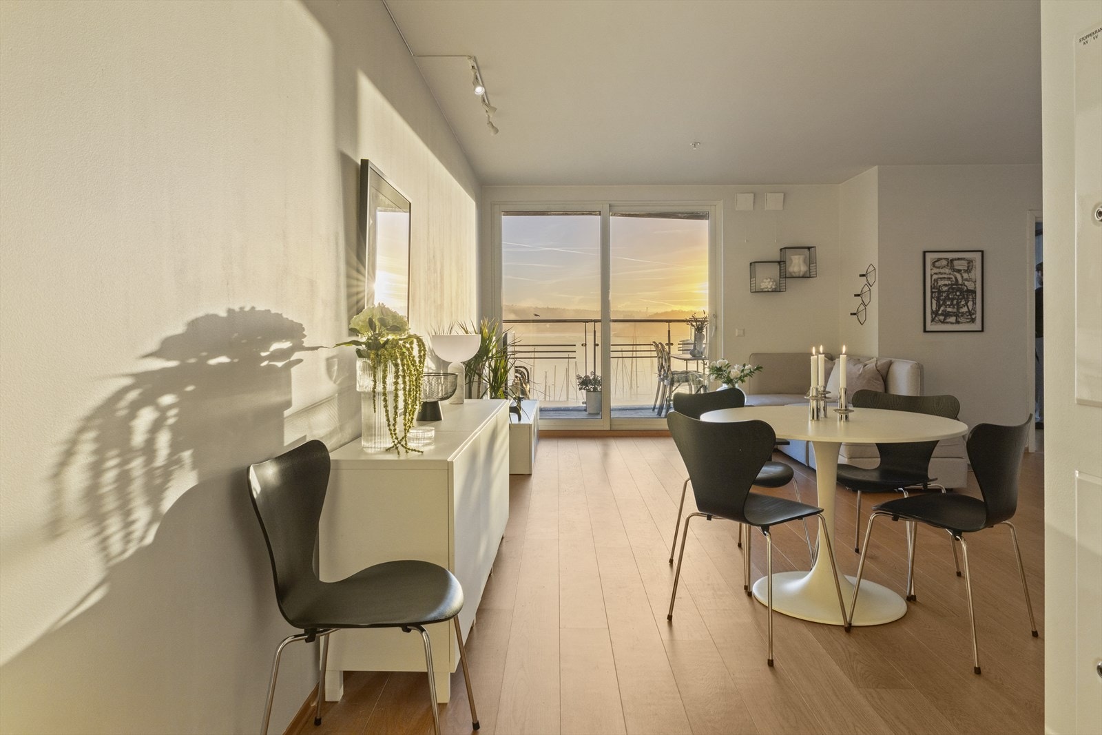 Det er lys eikeparkett i leiligheten og store vindusflater ut mot sjøen. Galleribilde