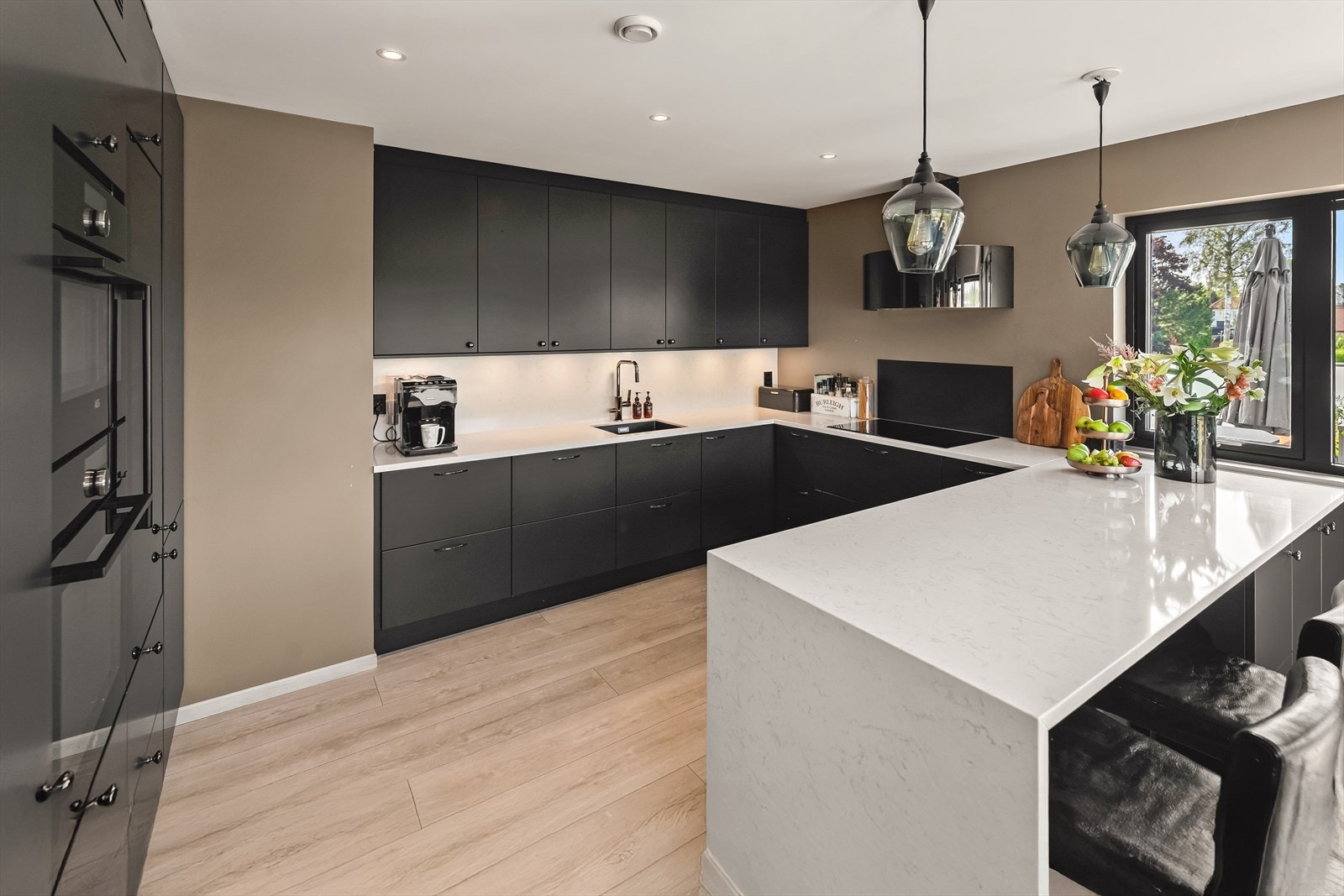 Det ligger tilbaketrukket fra deler av stuen, med mulighet for både sosial matlaging og skjermet arbeidsro. Galleribilde