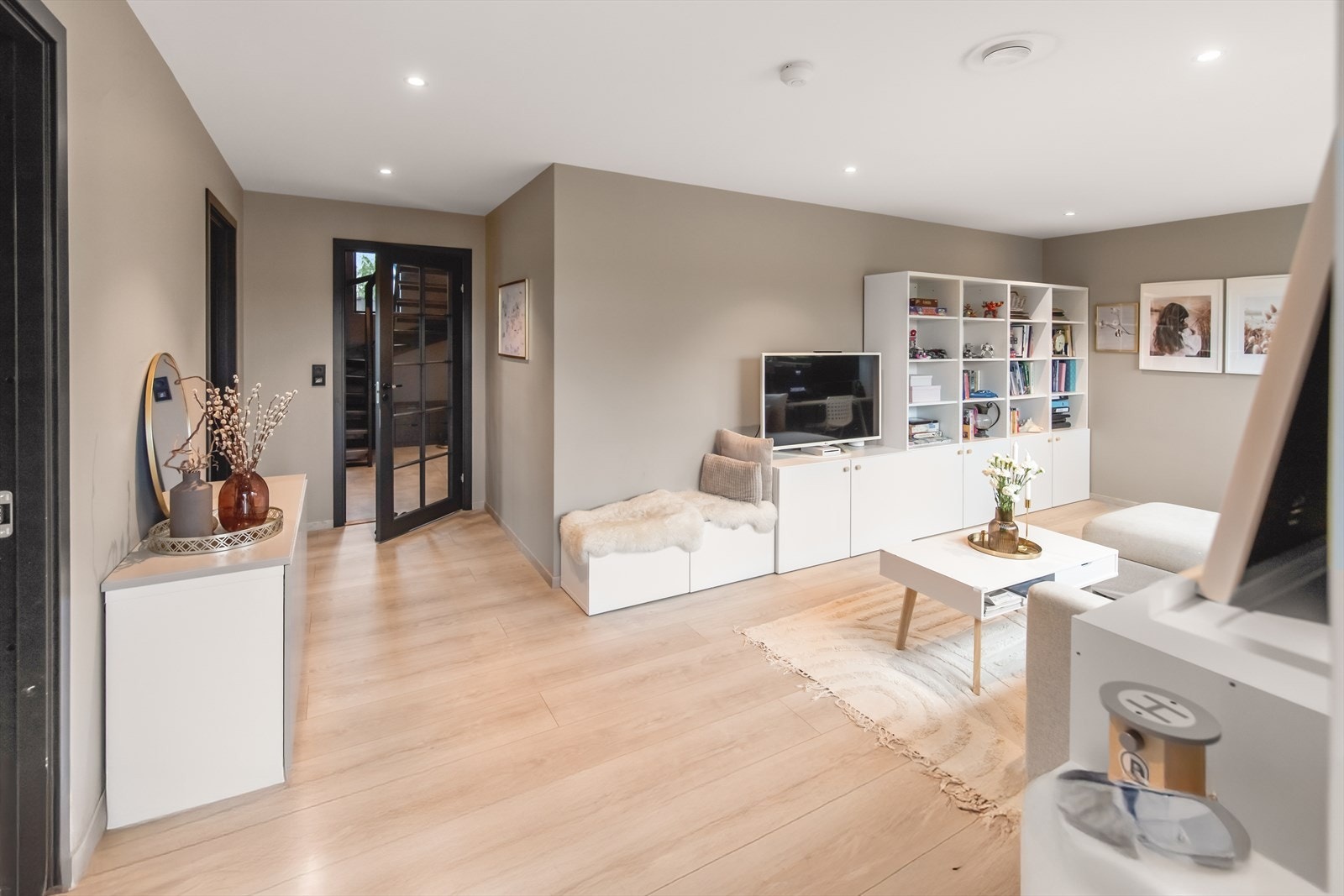 Ut til entreen har stuen en stilren glassdør, og det er direkte utgang til markterrassen i hagen. Galleribilde