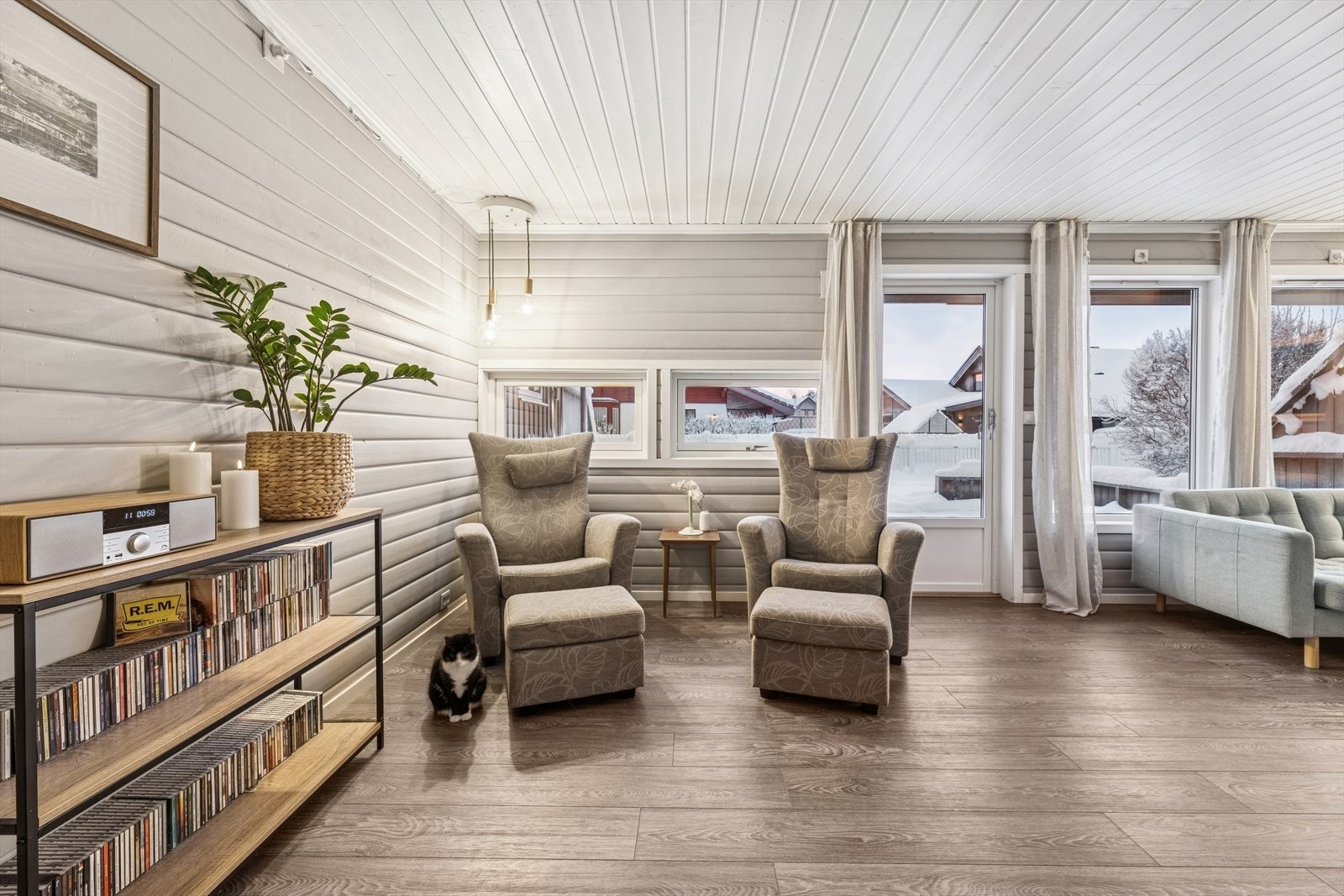 Store vindusflater slipper inn rikelig med naturlig lys og gir rommet en lys og luftig atmosfære. Galleribilde