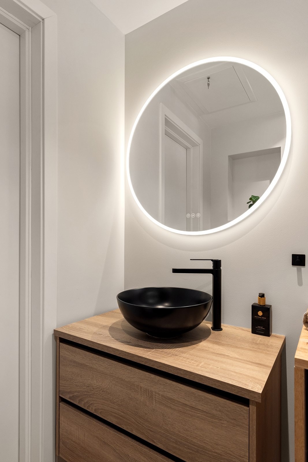 Speil med belysning samt stikkontakt på vegg over servant Galleribilde