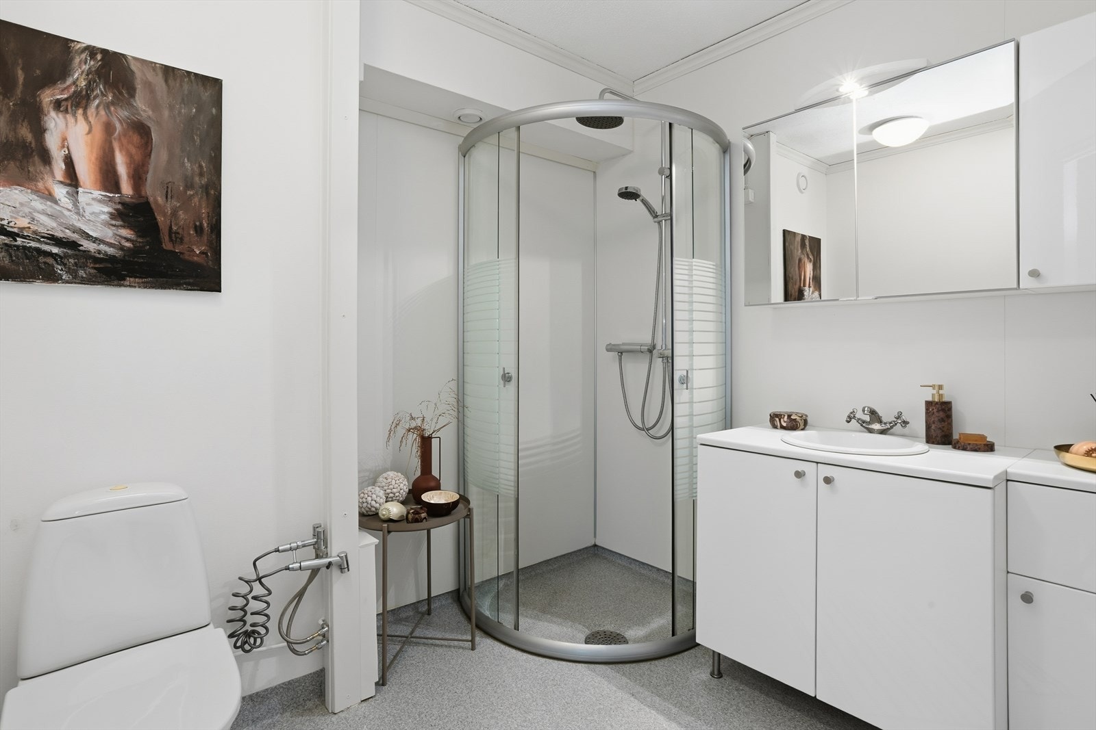 Badet er innredet med toalett og dusjvegger/hjørne og innredning med nedfelt servant. Galleribilde