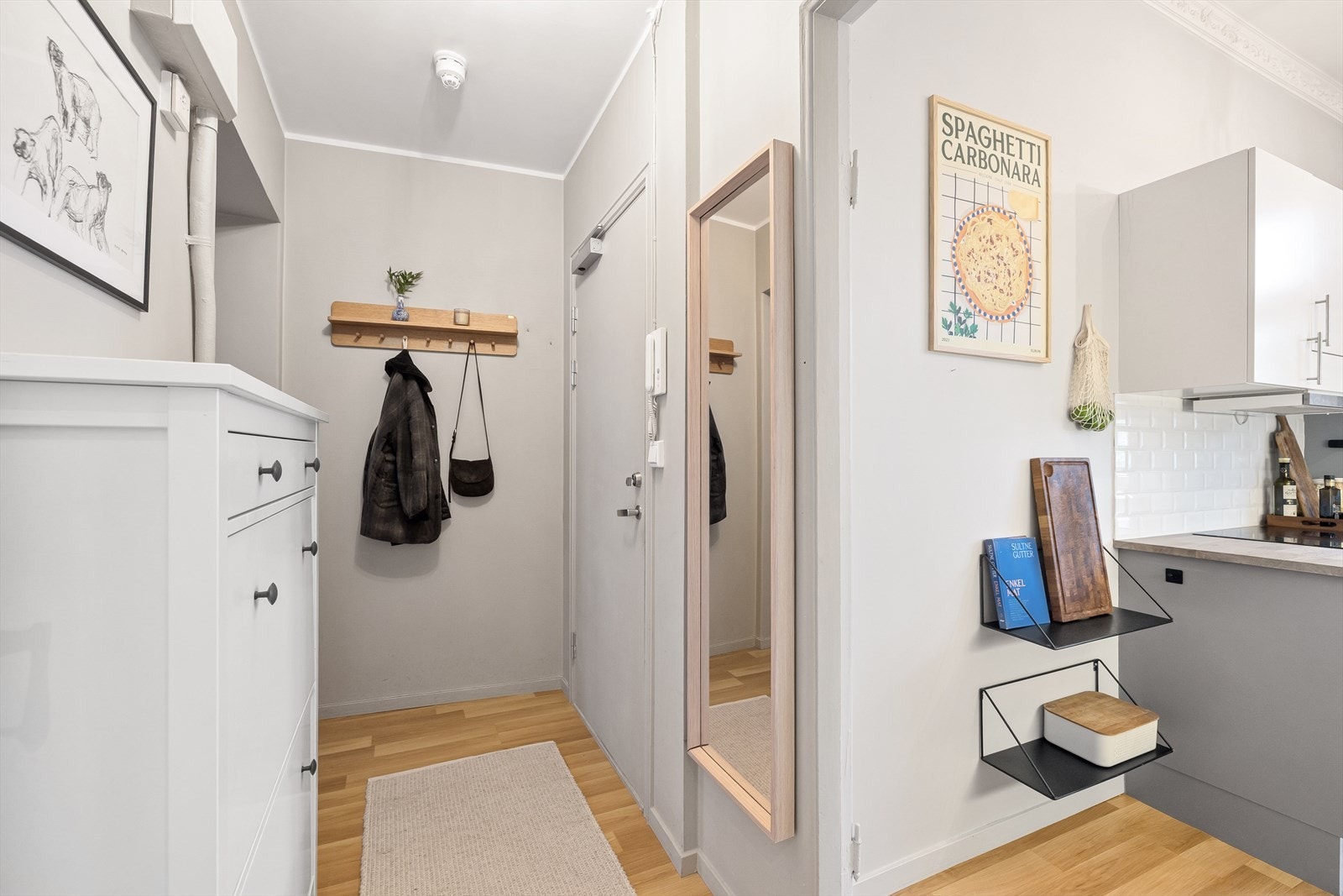 Direkte tilgang til kjøkkenet fra entréen gir en praktisk løsning for matlaging og oppbevaring. Galleribilde