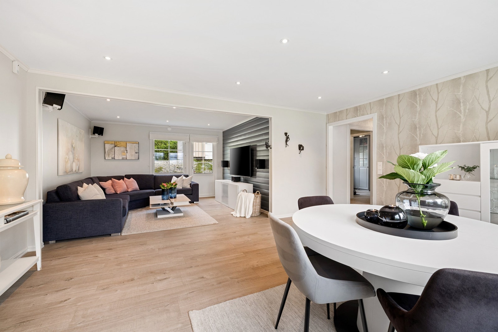 Lys og åpen stue med spotter i tak. Galleribilde