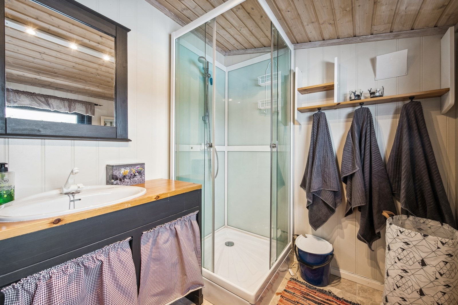 Baderommet inneholder dusjkabinett, servant og forbrenningstoalett. Galleribilde