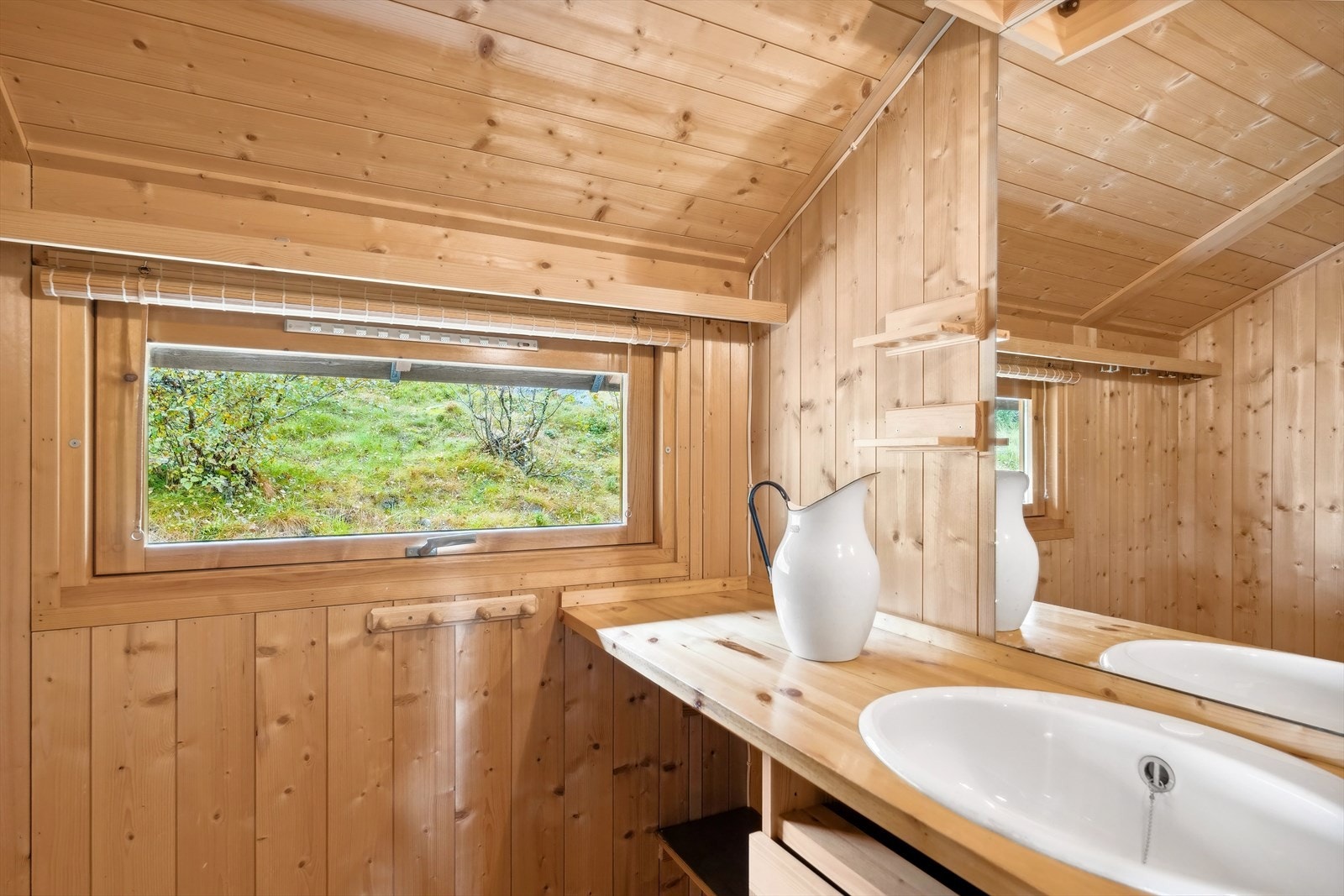 Det er også et eget rom med benkeplate og utslagsvask med både hyller og skap under benken. Galleribilde