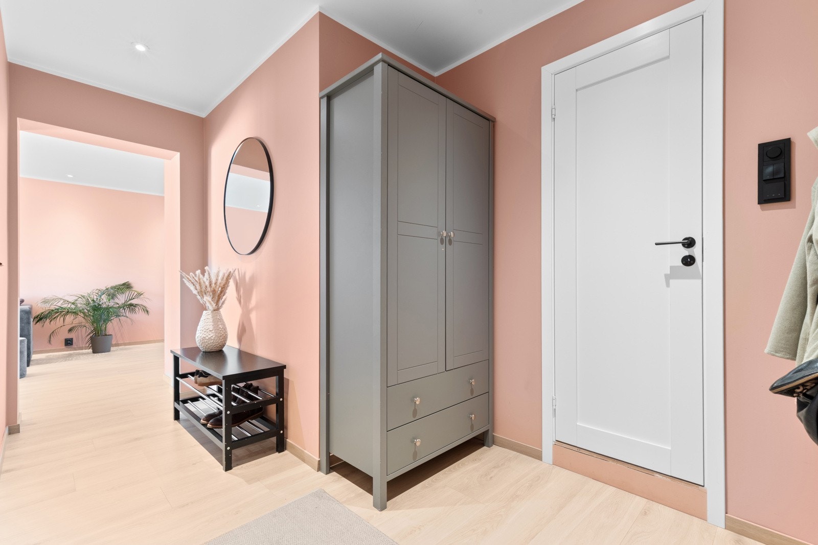 Entréen har lys enstavs laminat på gulv, glatte malte overflater, skjult elektrisk anlegg og downlights i himlingen. I entréen har du plass til sko og yttertøy i medfølgende garderobeskap, samt ytterligere plass til oppheng, skoskap eller kommoder. Galleribilde