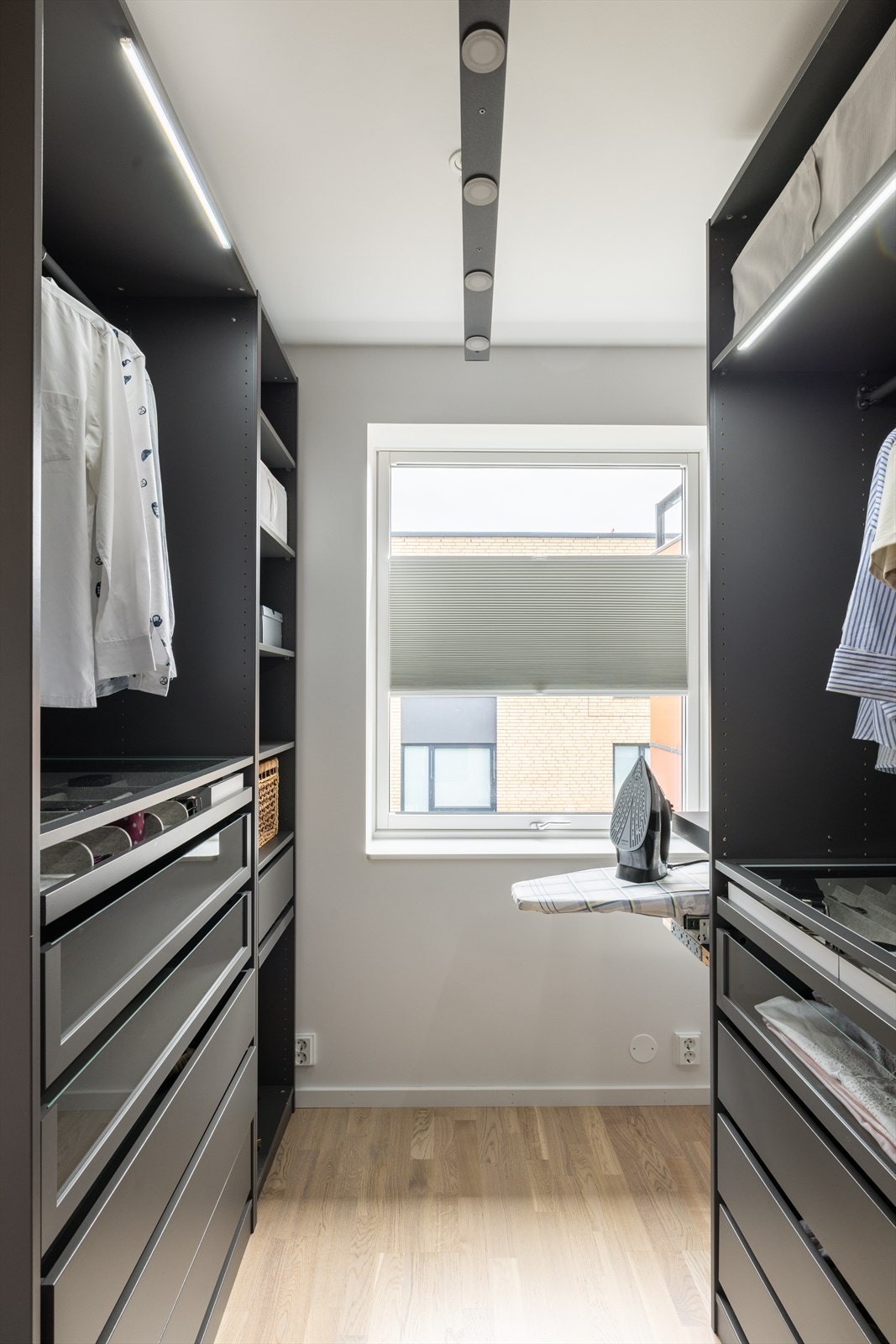 Rommet er smart innredet med romslige garderobeskap fra IKEA PAX-systemet, og har blant annet strykebrett og rikelig med oppbevaringsplass for hele husstanden. Galleribilde