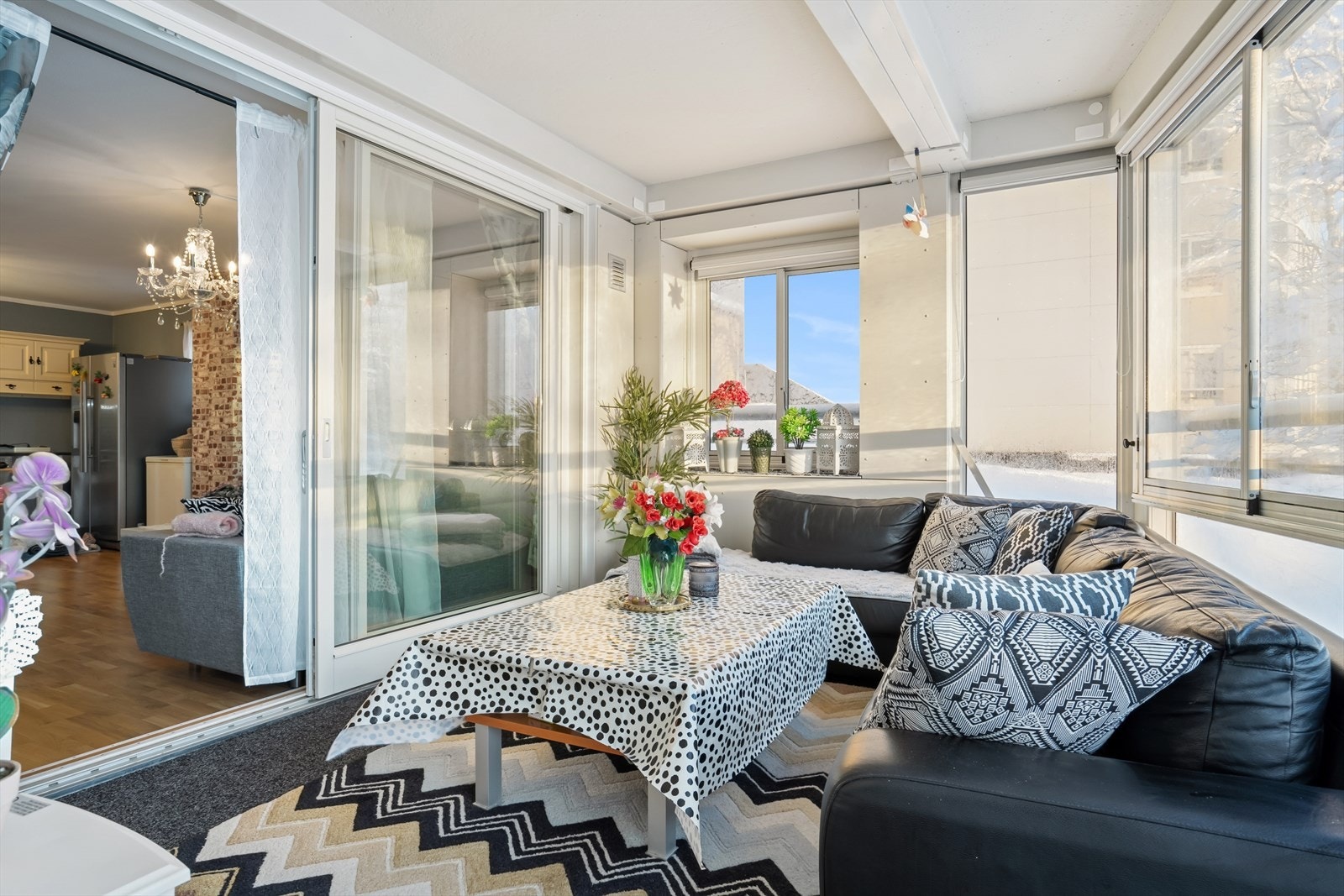 Fra stuen er det skyvedør i glass ut til den innglassede verandaen, som store deler av sommeren oppleves som en forlengelse av stuen Galleribilde