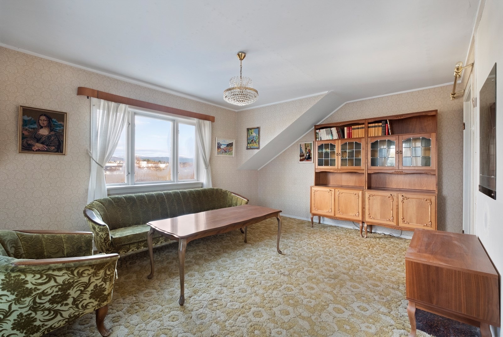 Store vinduer gir godt med naturlig lys i oppholdsrommet på loftet Galleribilde