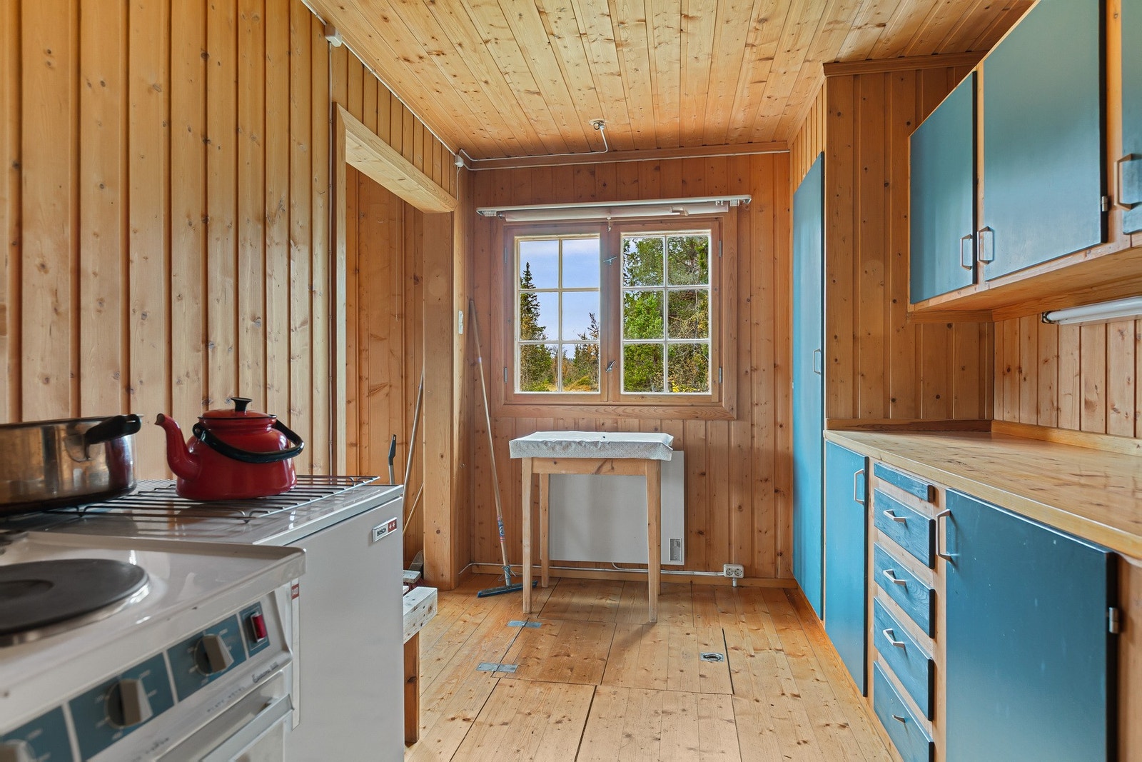 Oppbevaringsplass i over- og underskap, samt skuffer og høyskap. Montert utslagsvask, komfyr og kjøleskap. Galleribilde