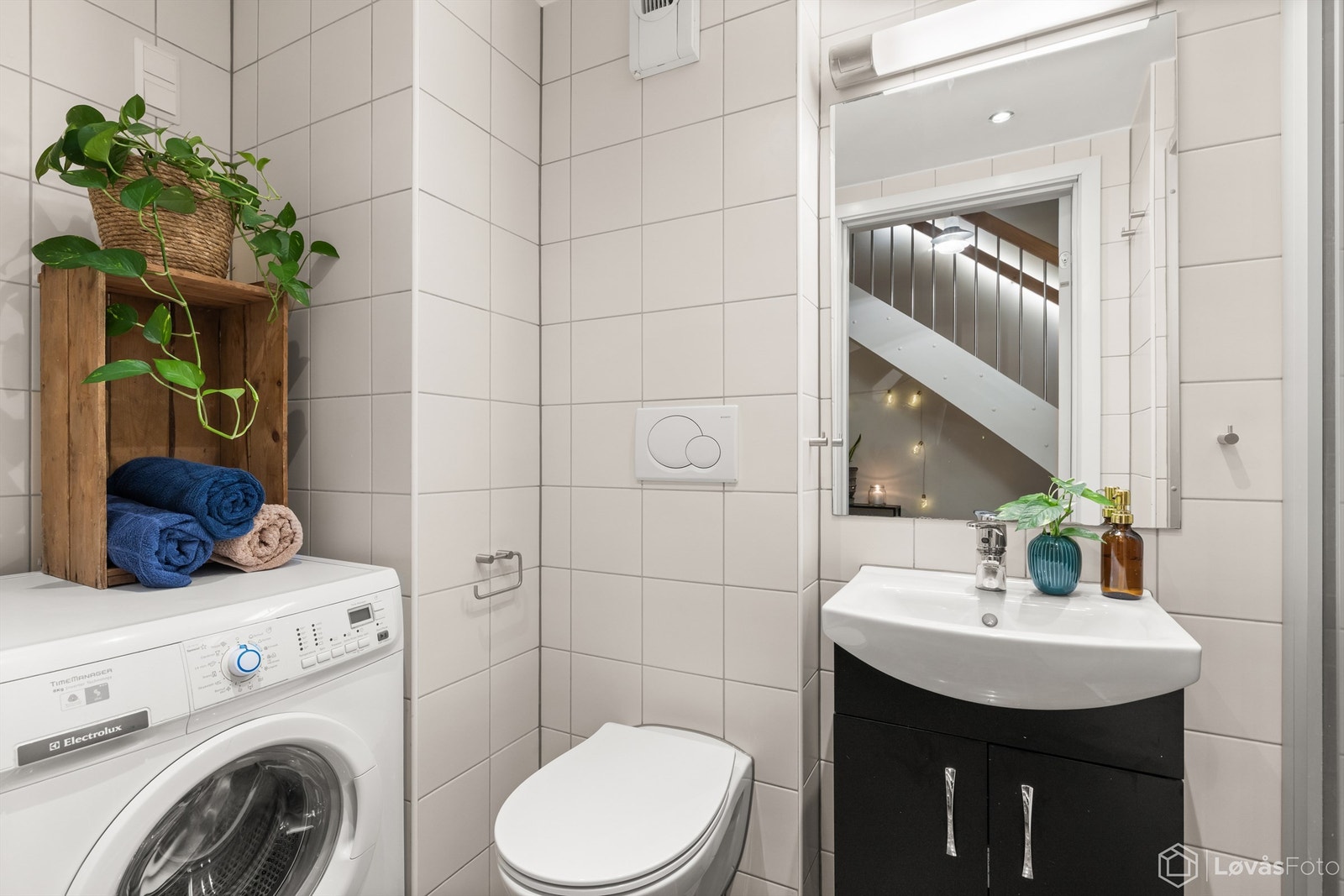 Pent, flislagt bad som er innredet med vegghengt servantskap med overpåliggende servant (nytt i 2025), vegghengt toalett, og dusjsone med delvegg og skyvedører av glass og metall. Opplegg til vaskemaskin/tørketrommel. Galleribilde